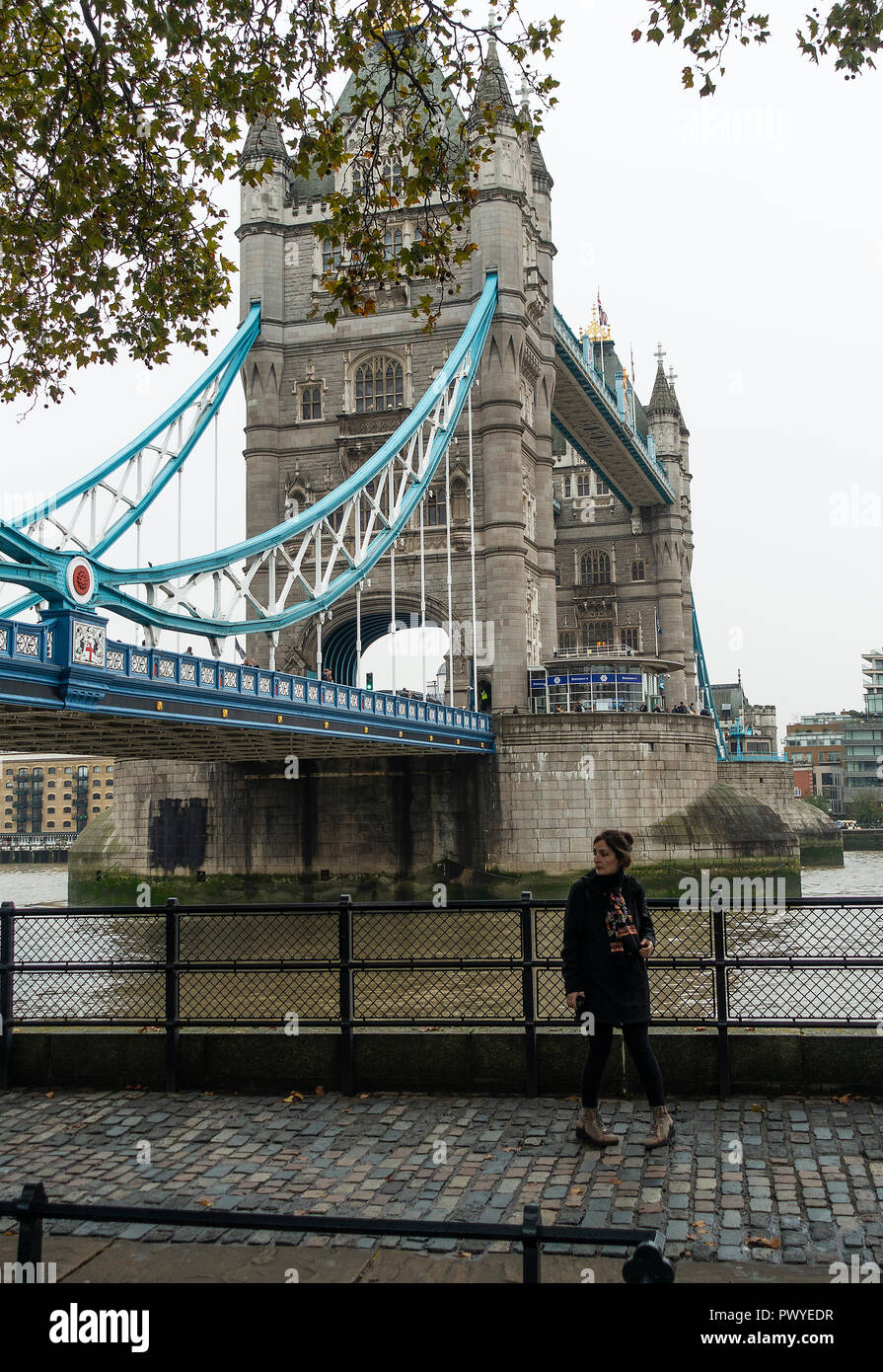 A Female Tourist Enjoying the North Bank Path at Tower Bridge on the River Thames London England United Kingdom UK Stock Photo