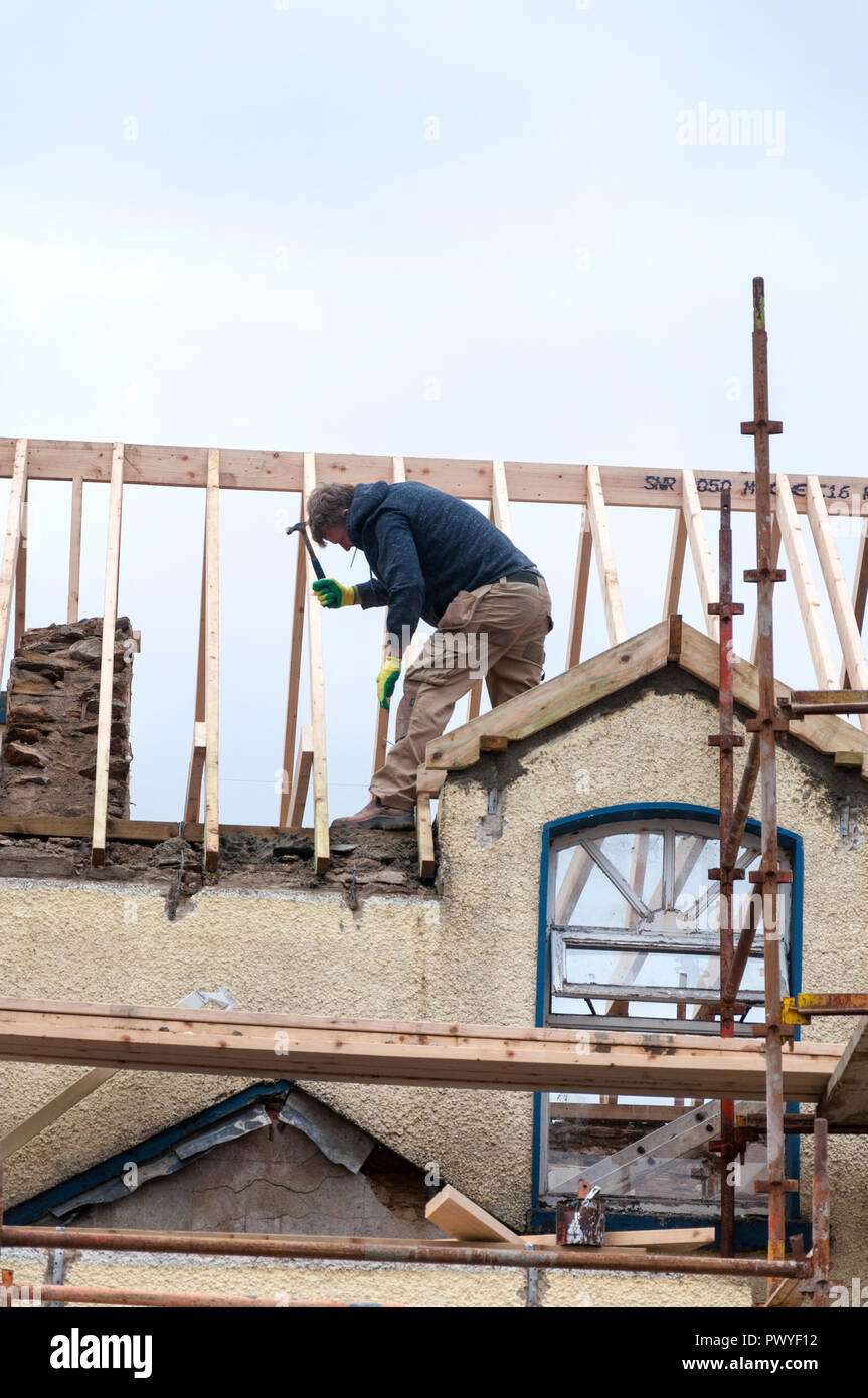 House renovation construction a roofing worker at work Stock Photo