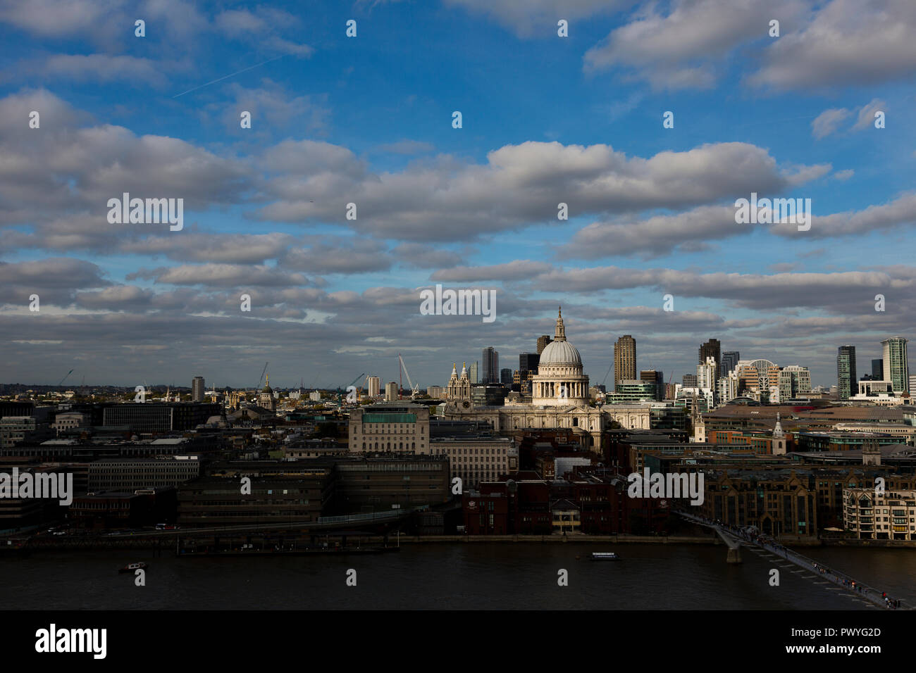 London, UK. The dome of St Paul's Cathedral reflecting late afternoon light as it towers above smaller nearby buildings. Stock Photo