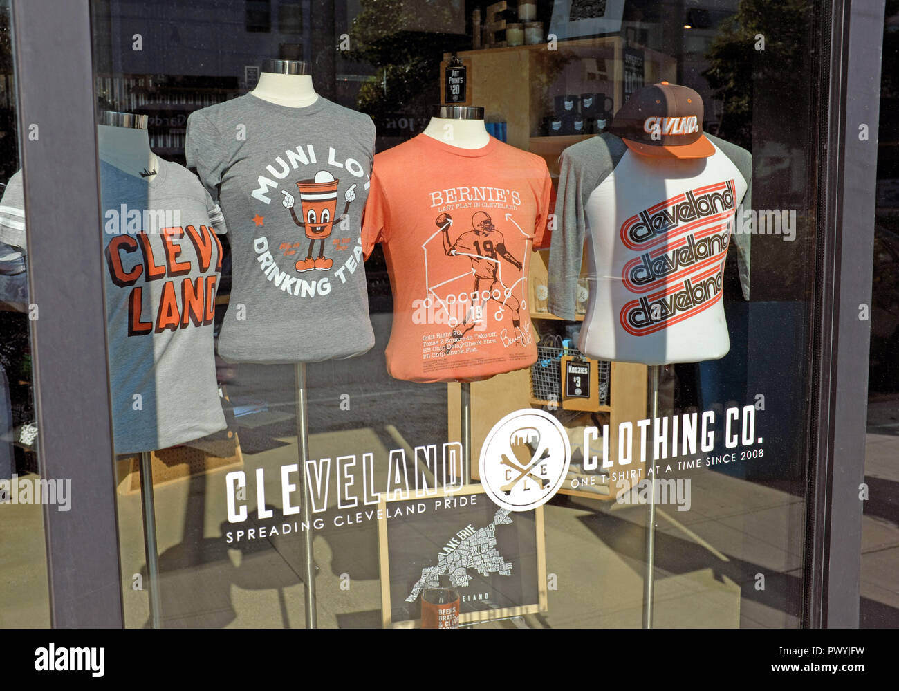 A window display along Euclid Avenue in Cleveland, Ohio shows t-shirts extolling Cleveland pride by the Cleveland Clothing Company. Stock Photo