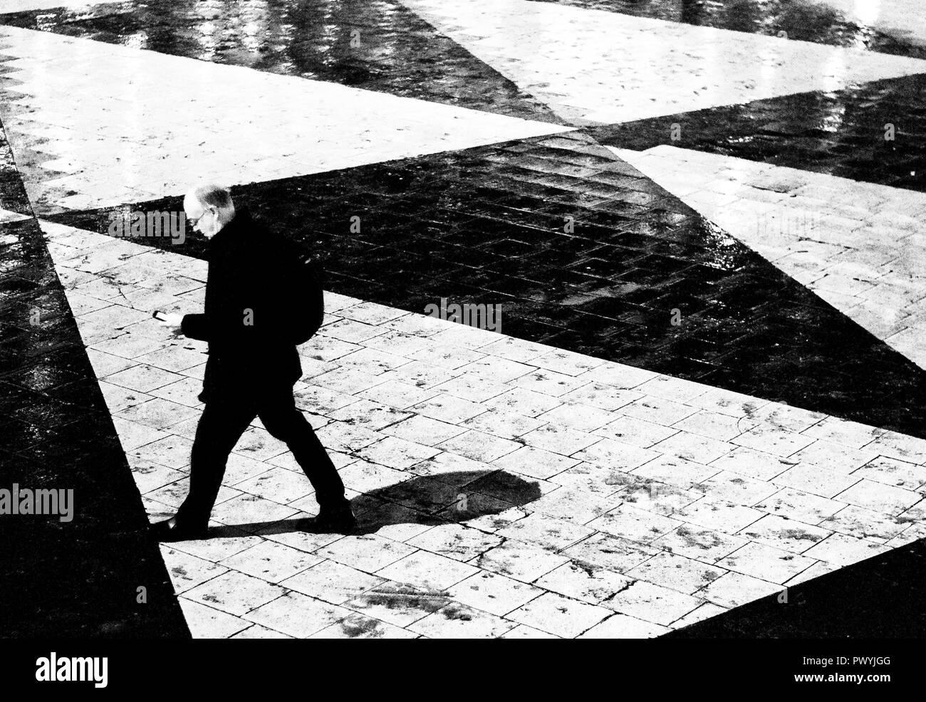 Elderly man walking phone Black and White Stock Photos & Images - Alamy