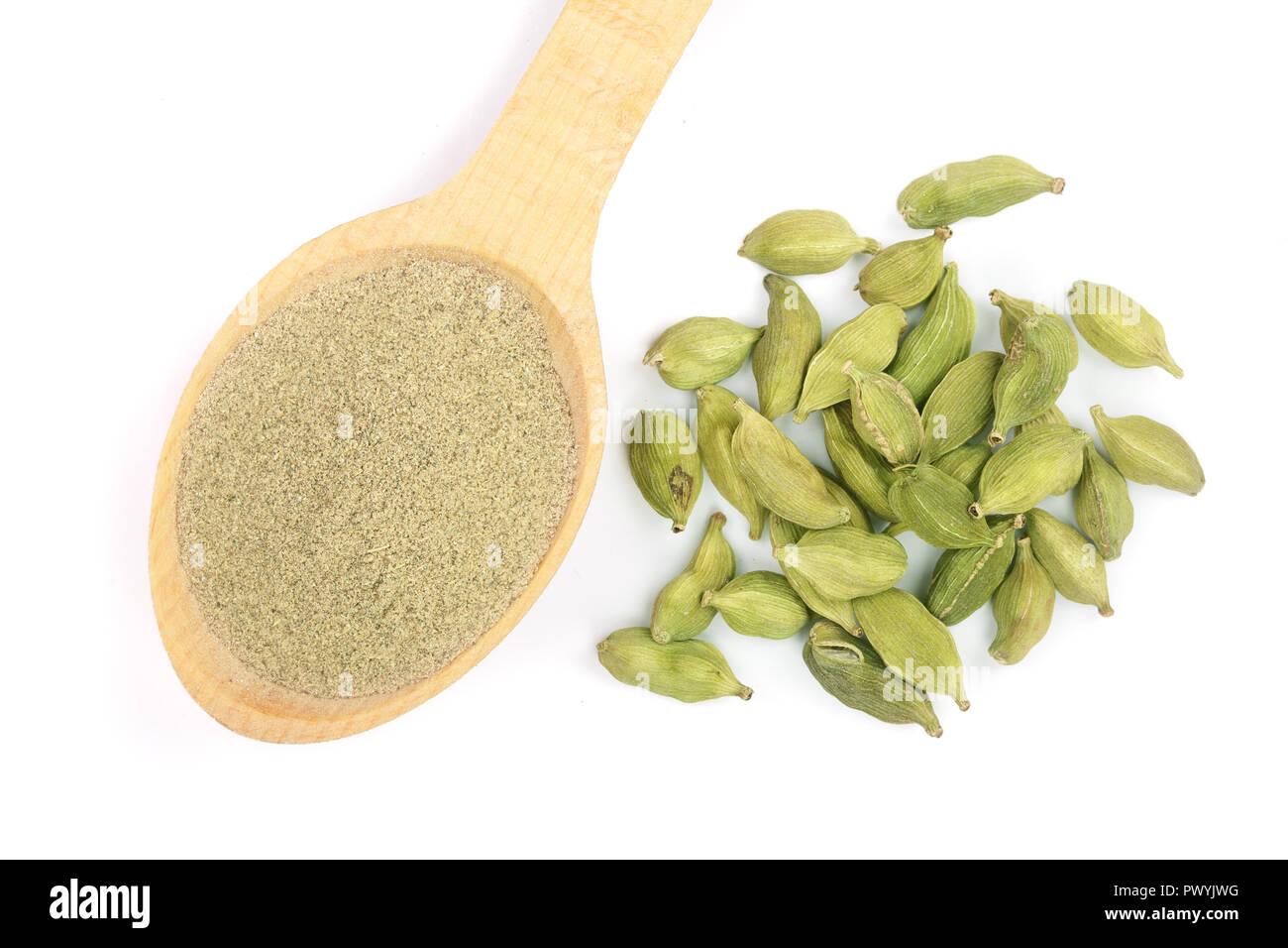 Green cardamom seeds and powder in a wooden spoon isolated on white