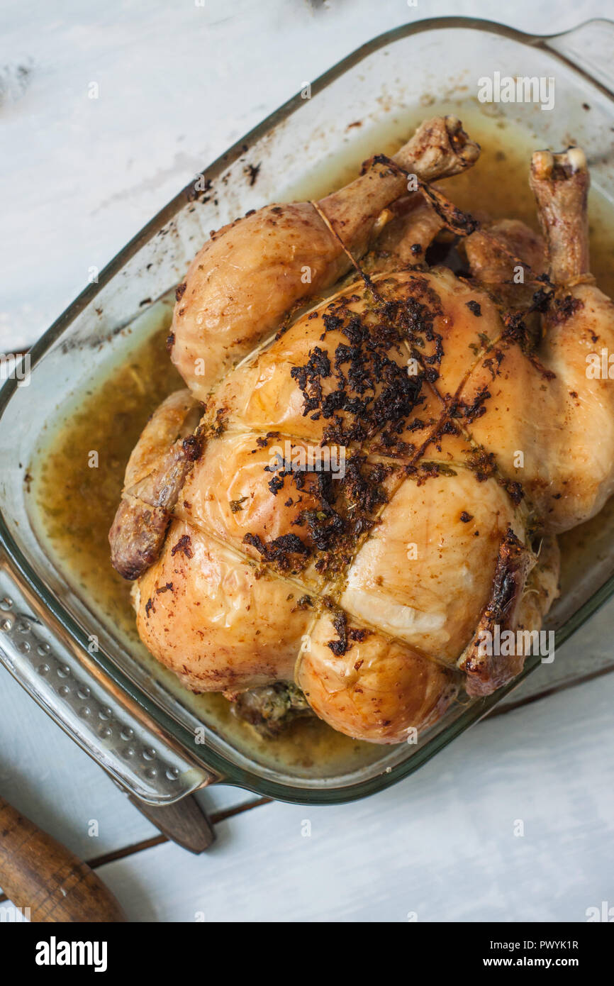 roasted chicken with garlic and butter on tray Stock Photo Alamy