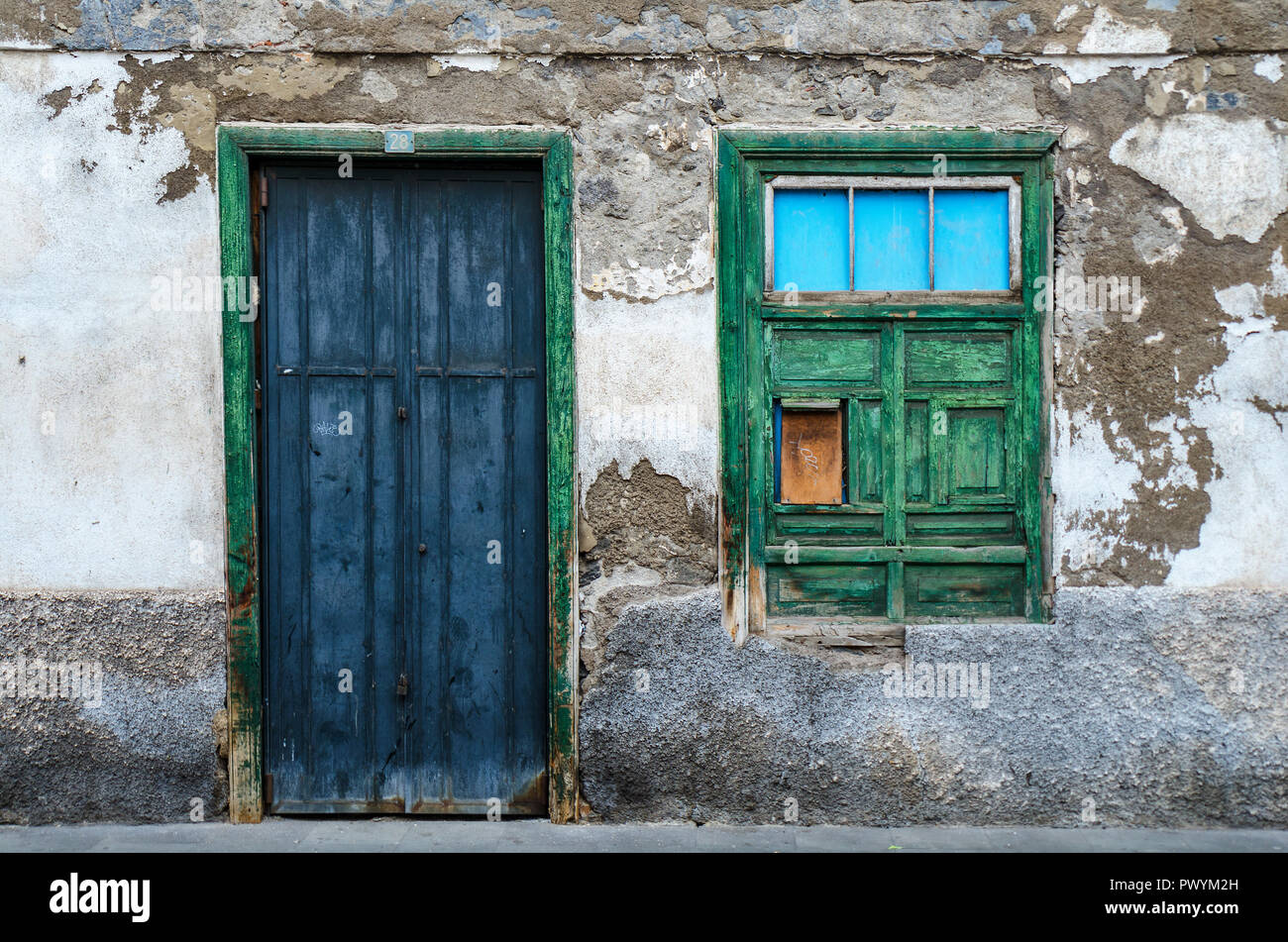 a blue door and a green window, facade of an old house Stock Photo - Alamy