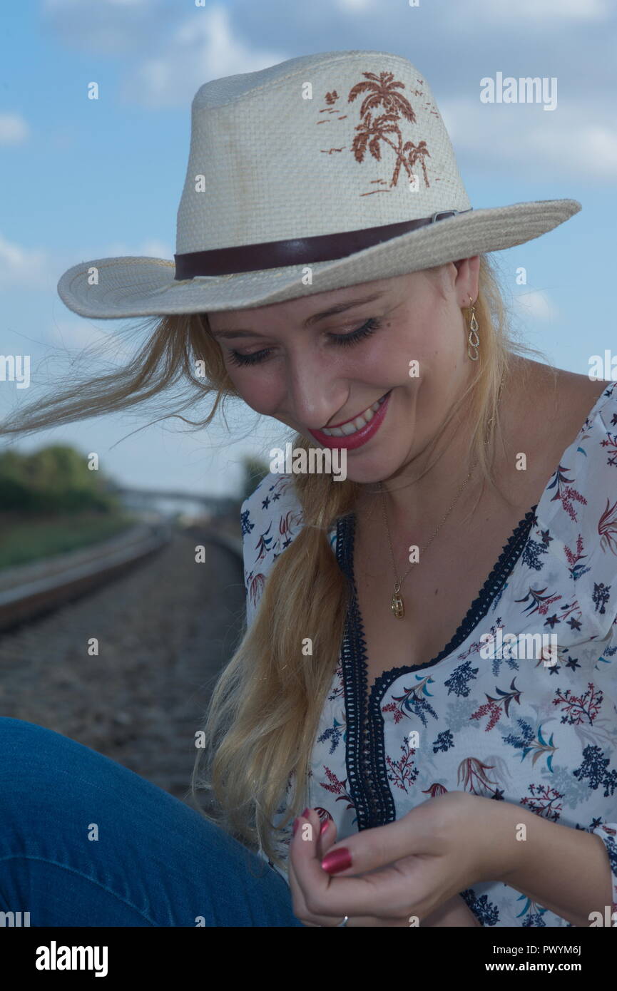 an amazing blonde lady with hat Stock Photo