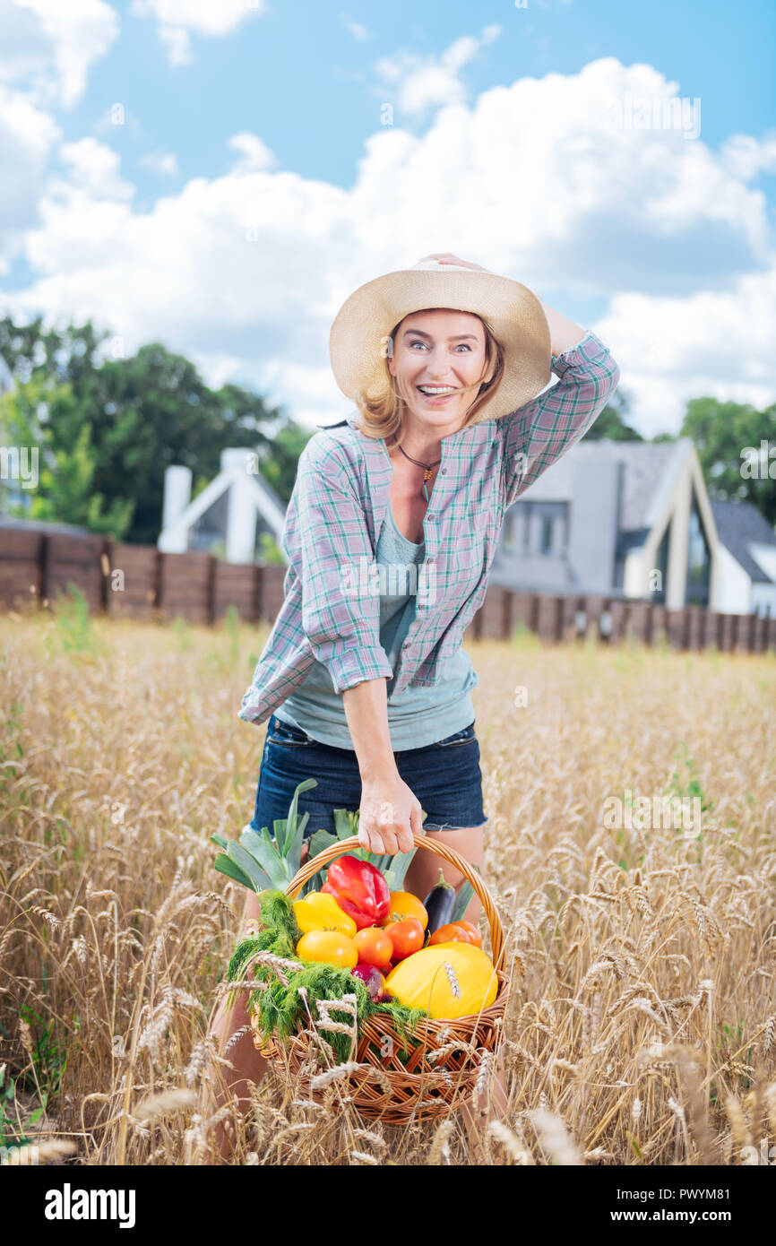 Appealing emotional woman feeling happy after harvesting vegetables Stock Photo