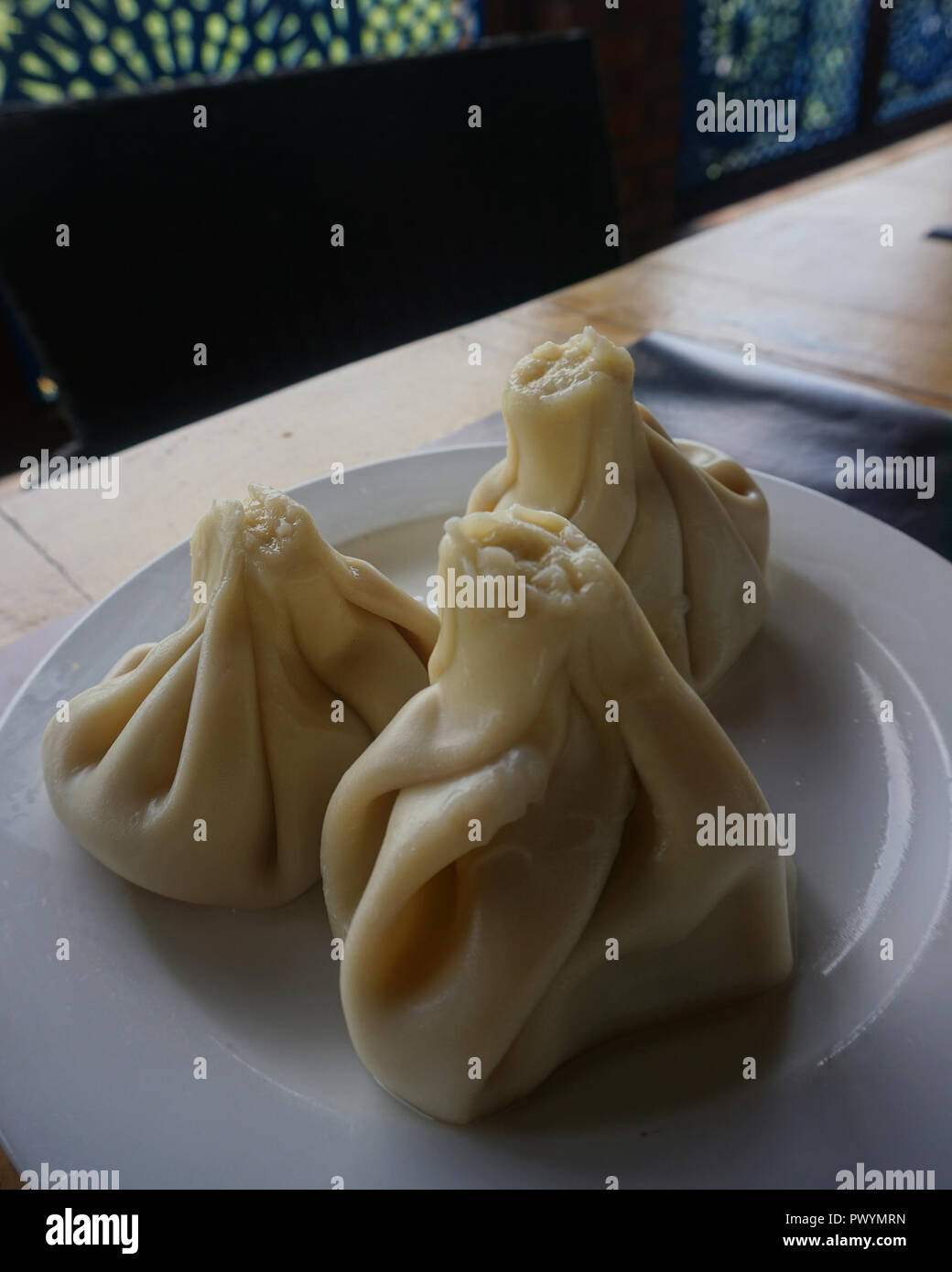 Georgian Three Steamed Meat Khinkalis Served on a Plate Stock Photo