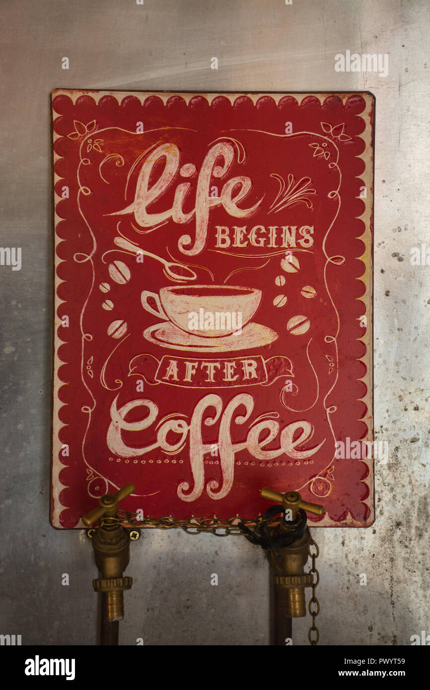 Red notice with the words Life begins after coffee. Amusing sign or board. Stock Photo