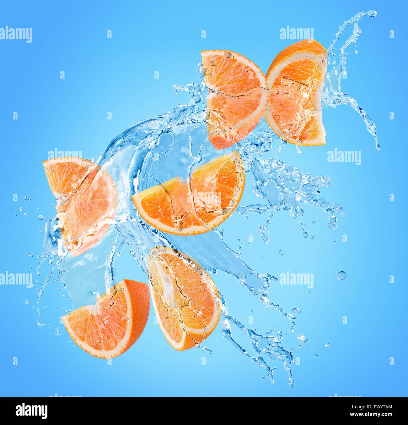 orange slices in water splash on a blue background Stock Photo - Alamy