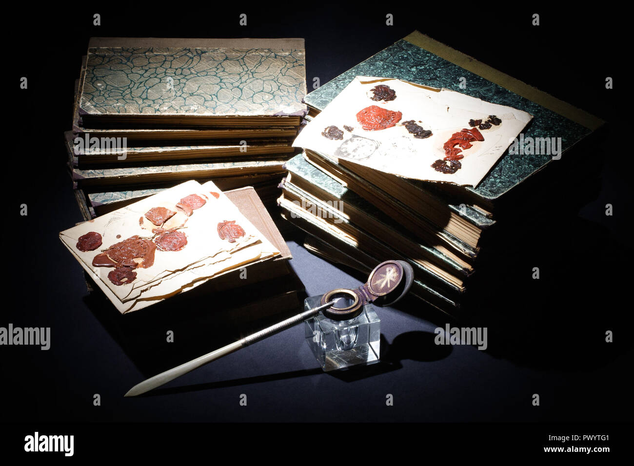 vintage concept - old books, papers, ink pen and inkpot on black ...
