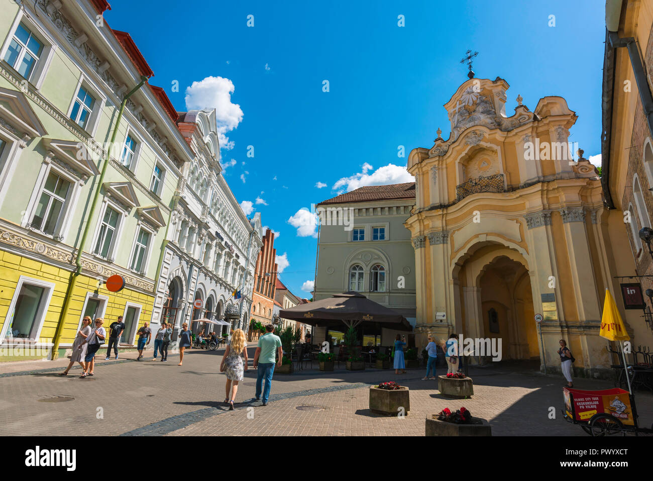 Vilnius old town, view along Didzioji Gatve, a main thoroughfare in the center of Vilnius Old Town, showing the Baroque porch of Holy Trinity Church. Stock Photo