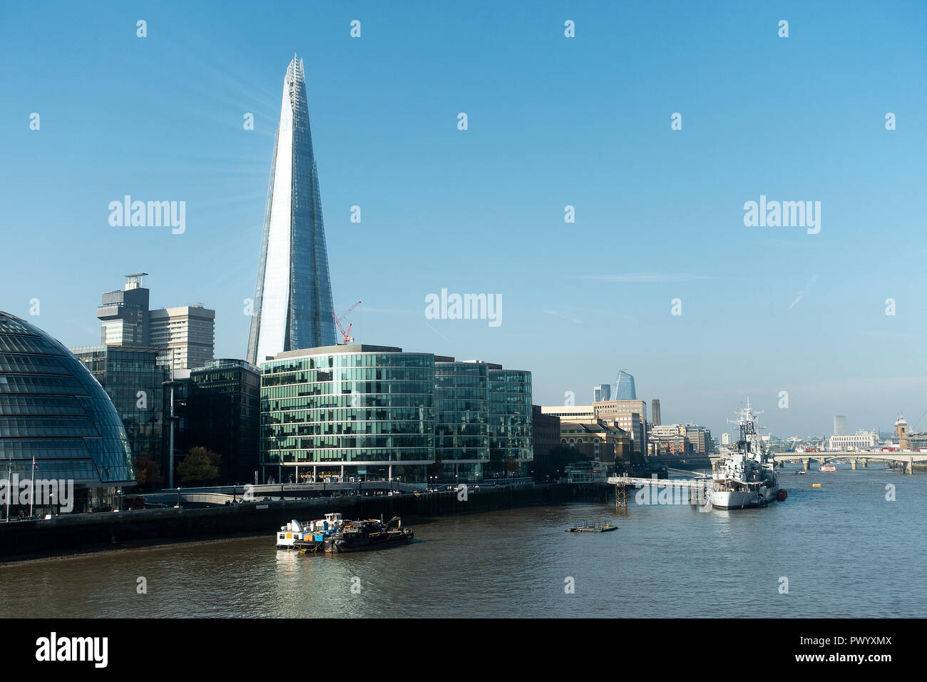 The Shard Skyscraper and HMS Belfast on the Southbank of the River Thames from Tower Bridge Tower Hamlets London United Kingdom UK Stock Photo