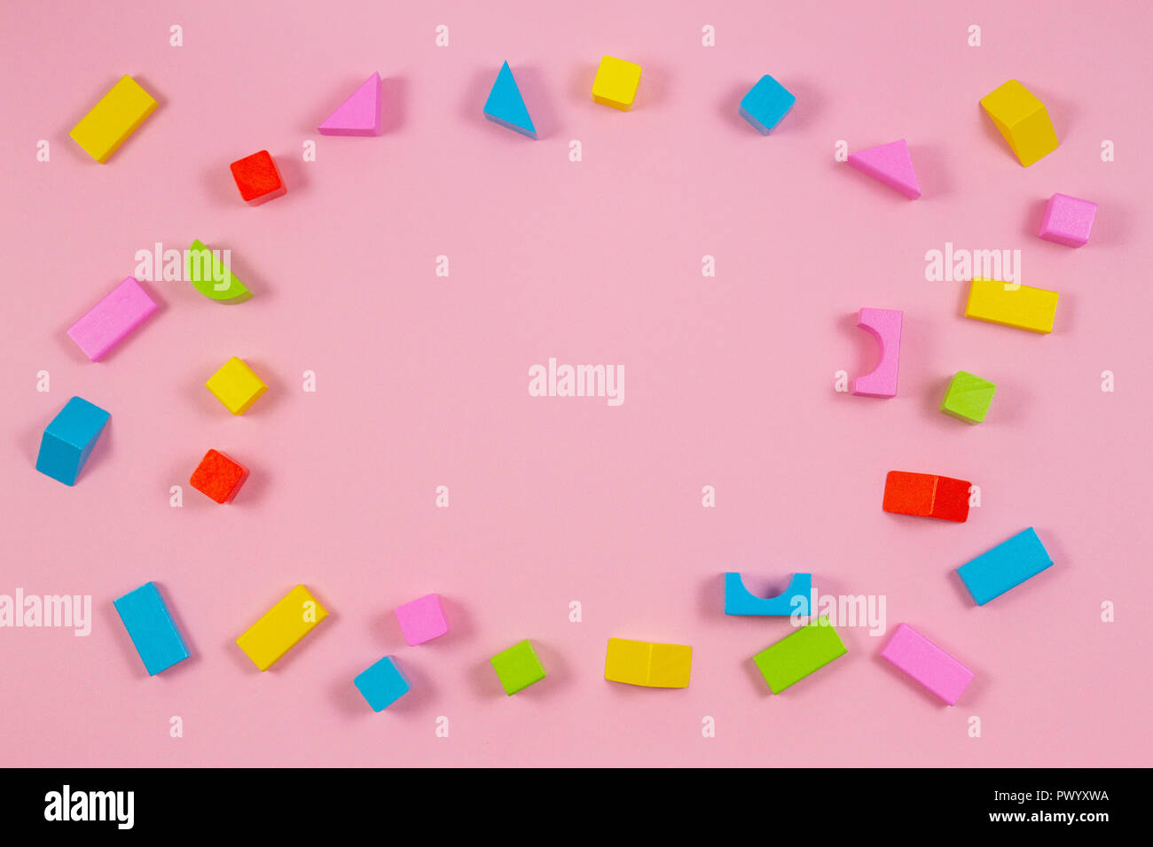 Colorful wooden building blocks on pink background Stock Photo Alamy