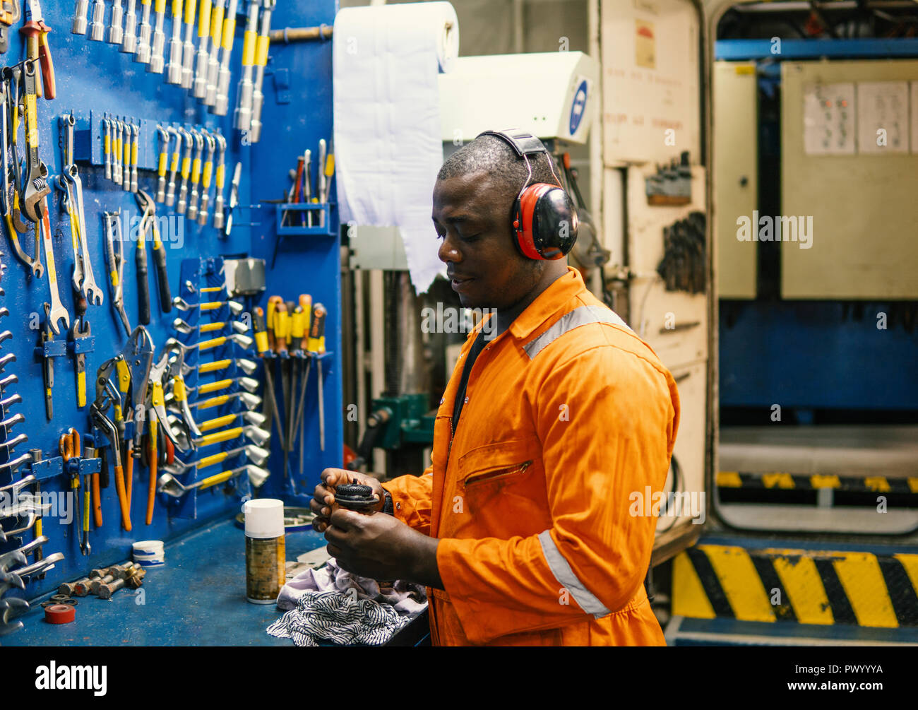 Marine engineer officer working in engine room Stock Photo Alamy
