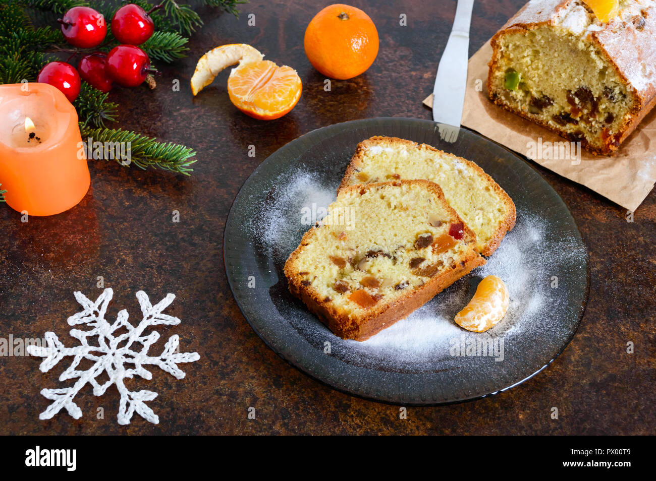 Christmas cake with nuts, dried fruit, tangerines. Traditional festive