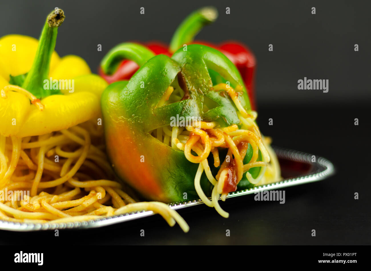 Color Stuffed Peppers With Scary Cutout Faces Halloween Party Food Fun Stock Photo Alamy