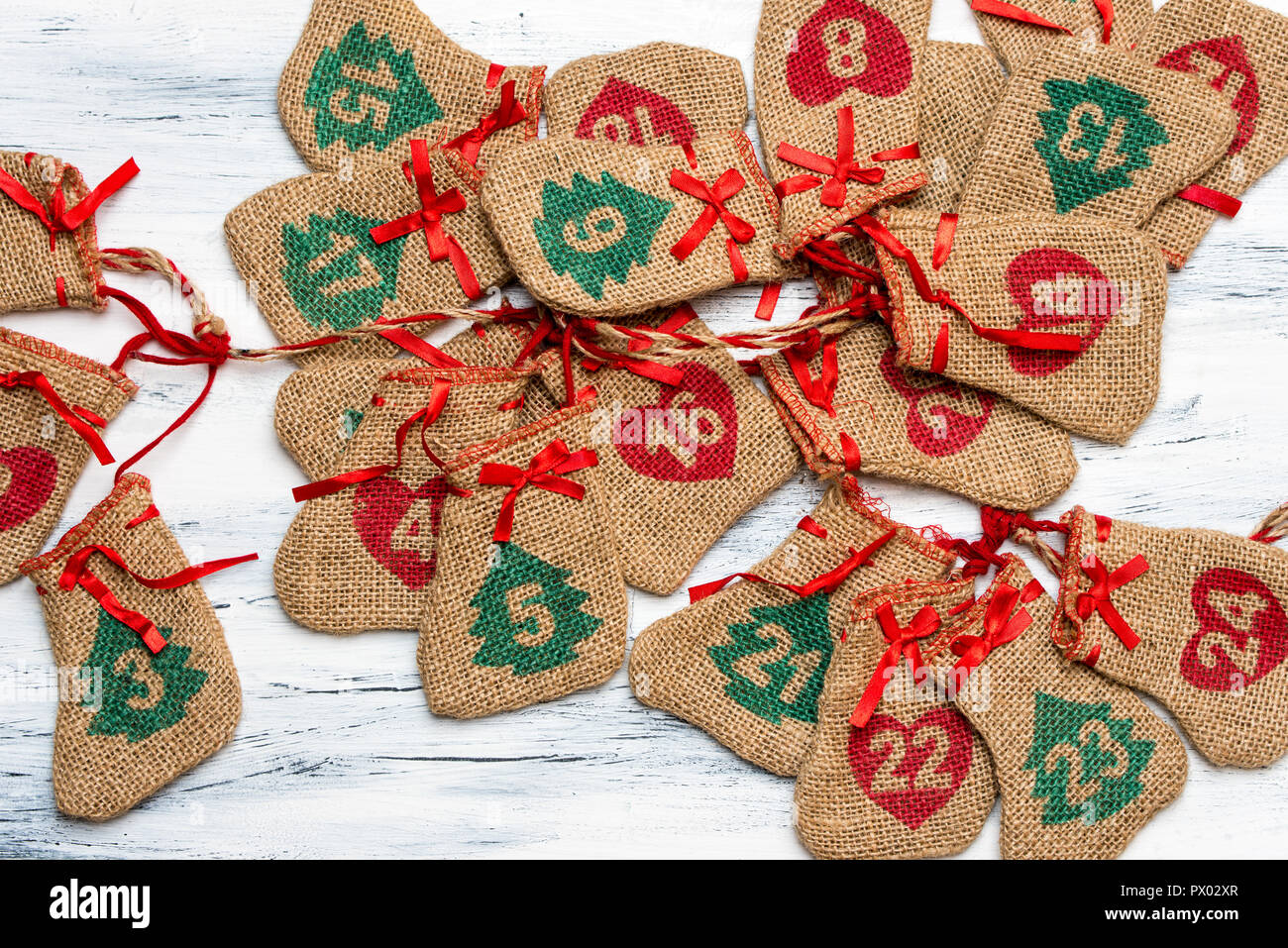 Advent calendar, on a light, wooden background lie plaited bags with days  on the calendar, free space for text Stock Photo - Alamy