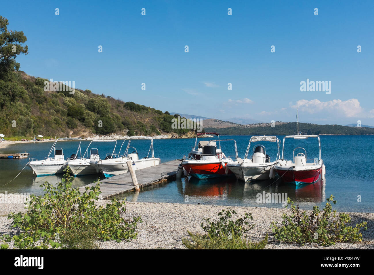 Pleasure motor boats moored at the harbour at Agios Stefanos in north east Corfu island Stock Photo