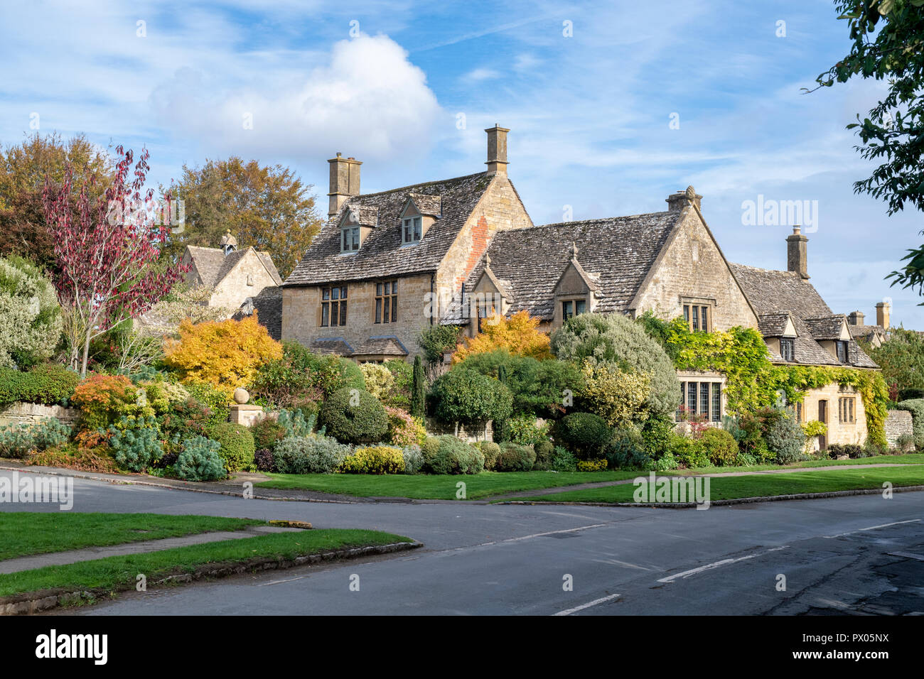 Autumn garden plant colours in front of a stone house. Chipping Campden, Cotswolds, Gloucestershire, England Stock Photo