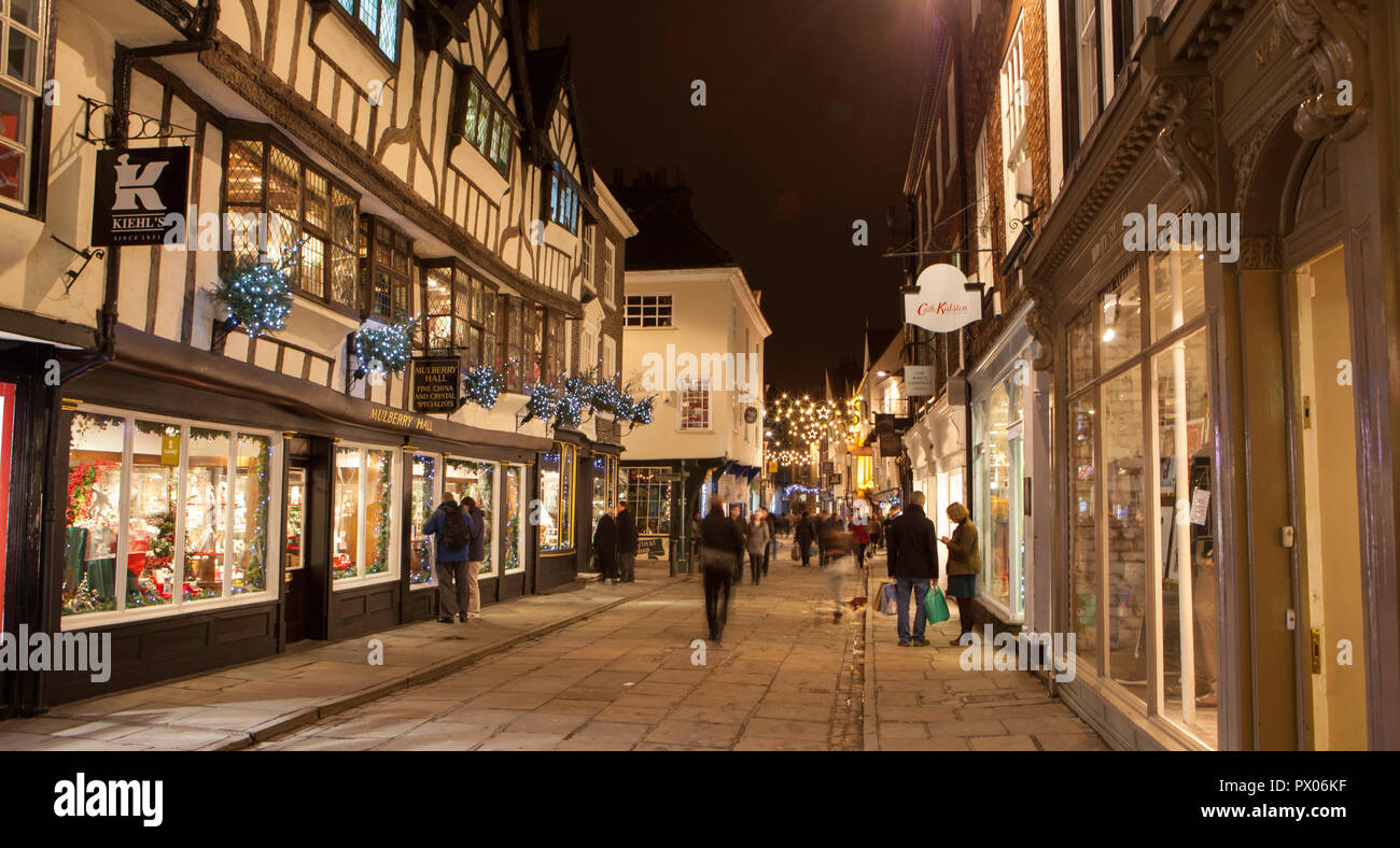 Night time photo of Stonegate in York with Christmas shoppers Stock Photo