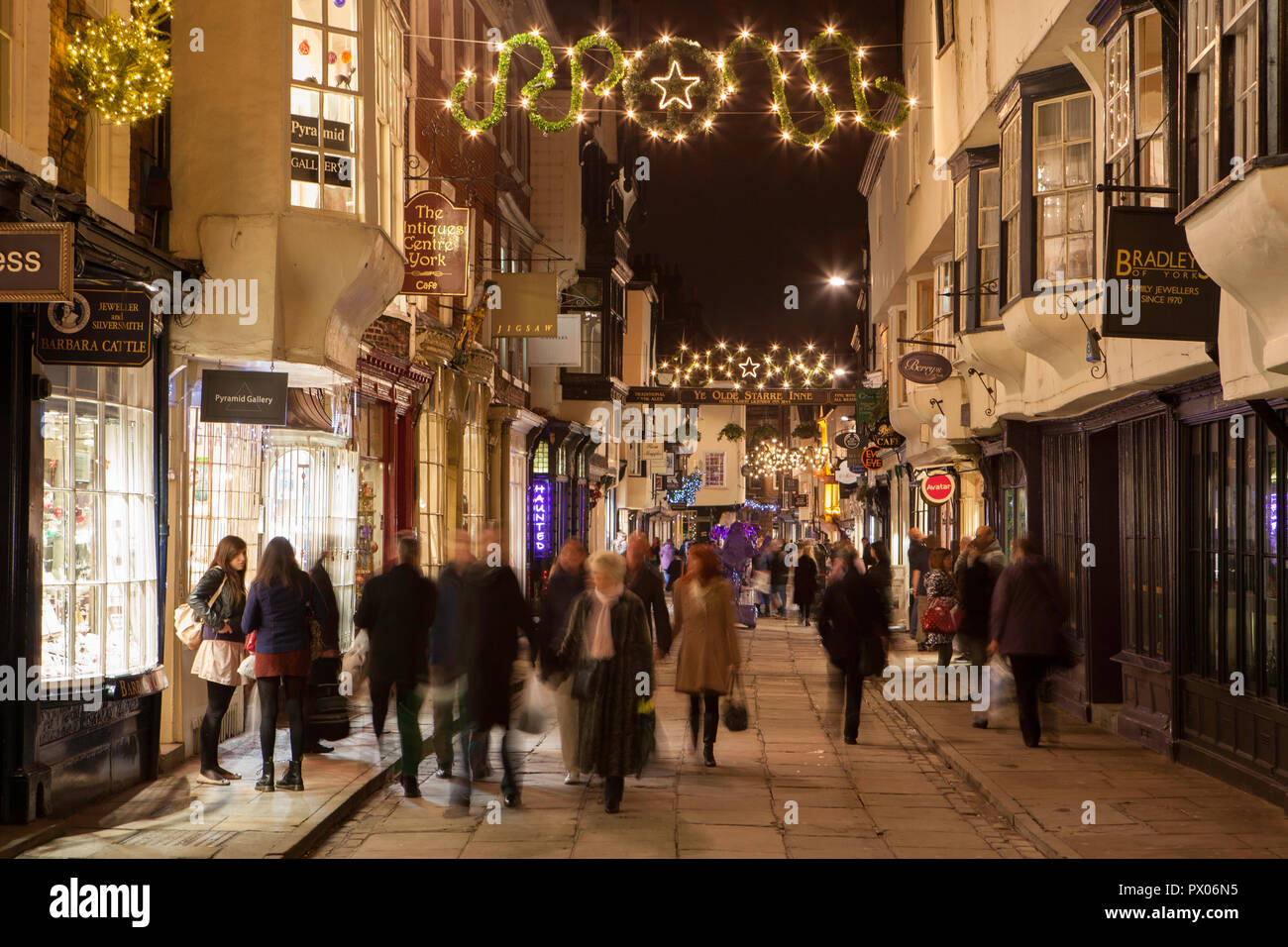 Night time photo of Stonegate in York with Christmas shoppers Stock Photo