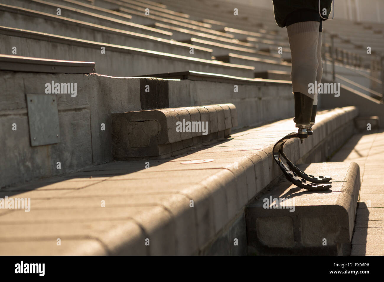 Disabled athletic sanding at sports venue Stock Photo