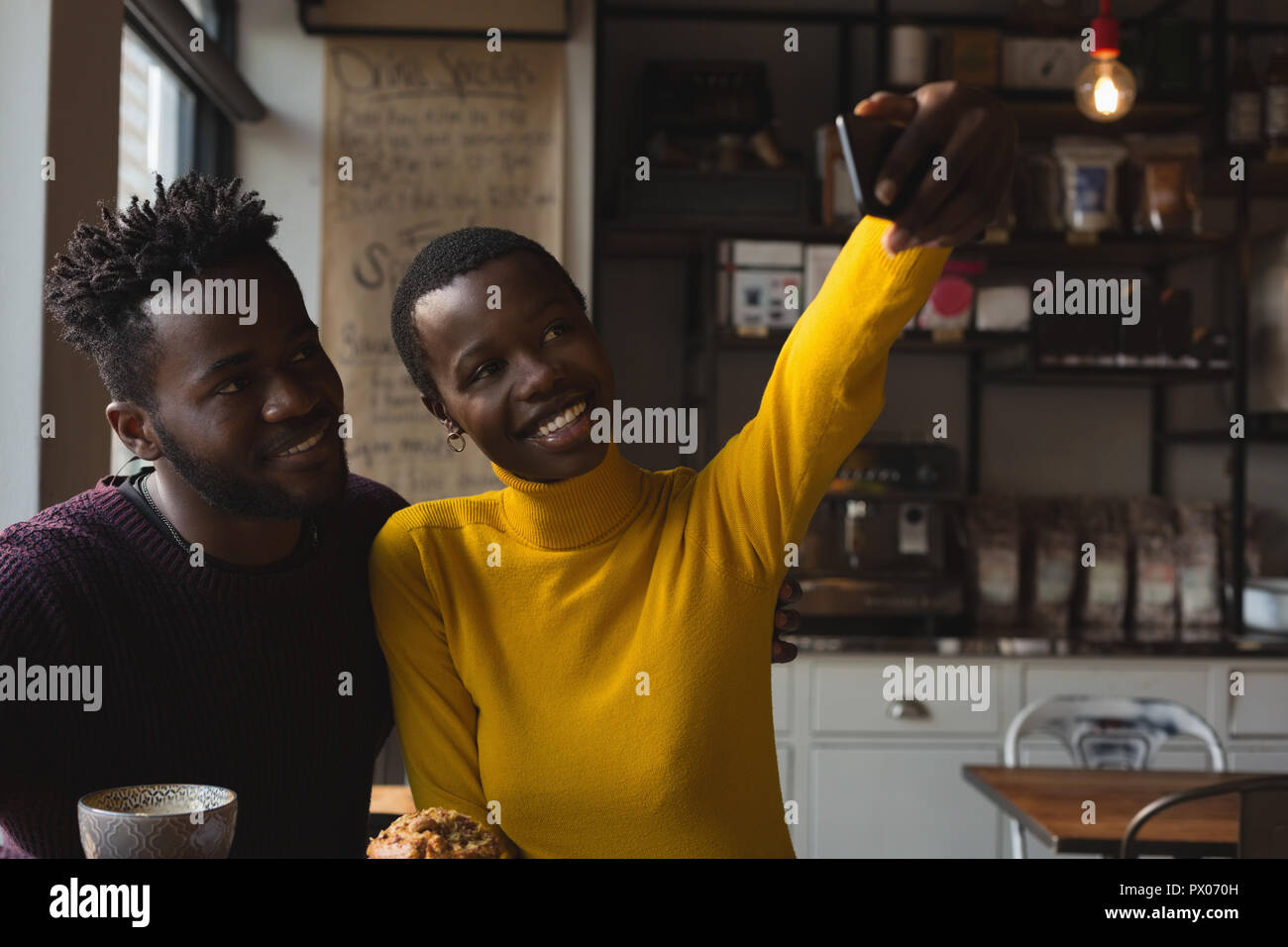 Couple taking selfie in cafe Stock Photo