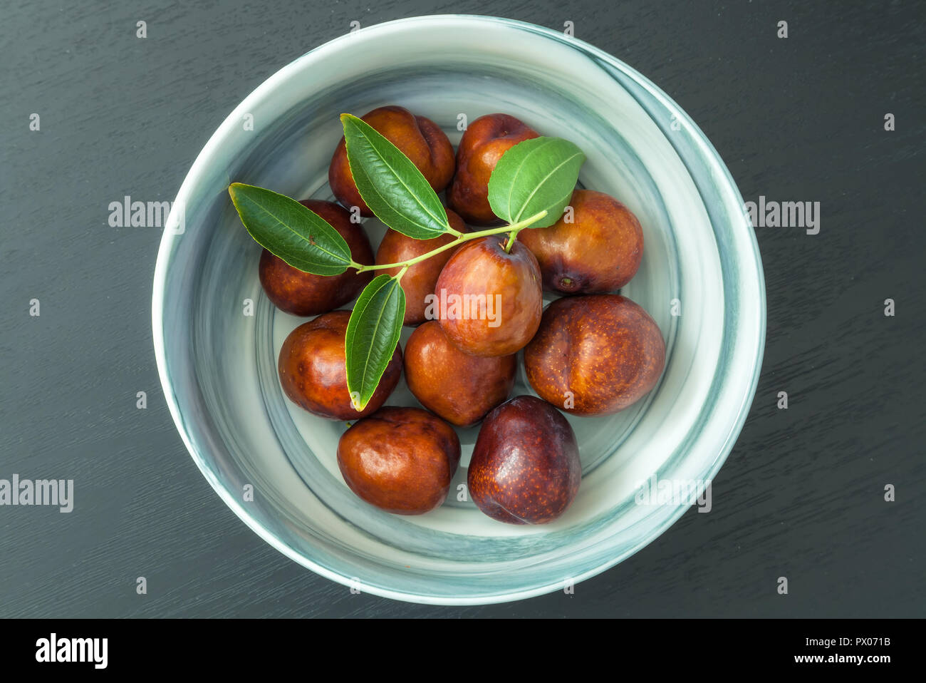 Bowl of fresh jujube fruit (Ziziphus jujuba) Stock Photo