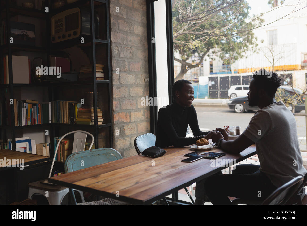 Couple interacting with each other in cafe Stock Photo