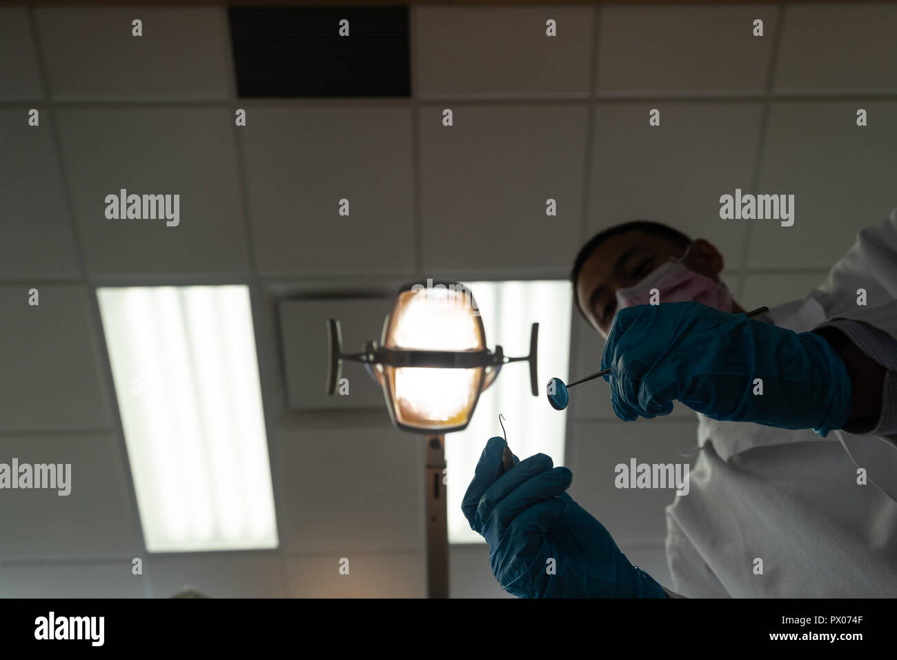 Low angle view of dentist holding tools Stock Photo