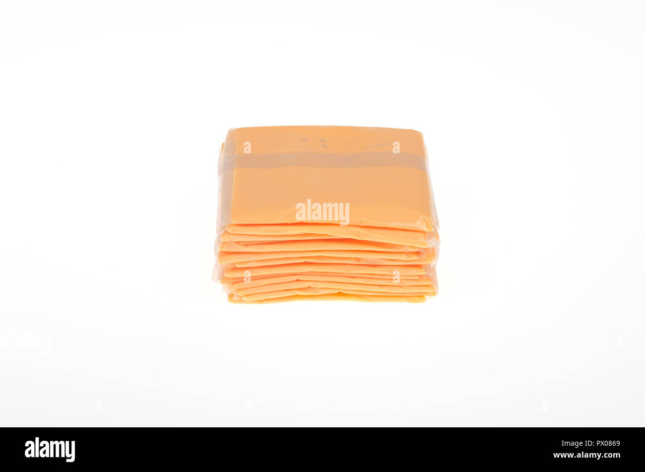 Stack of individually wrapped slices of orange american processed cheese on white Stock Photo