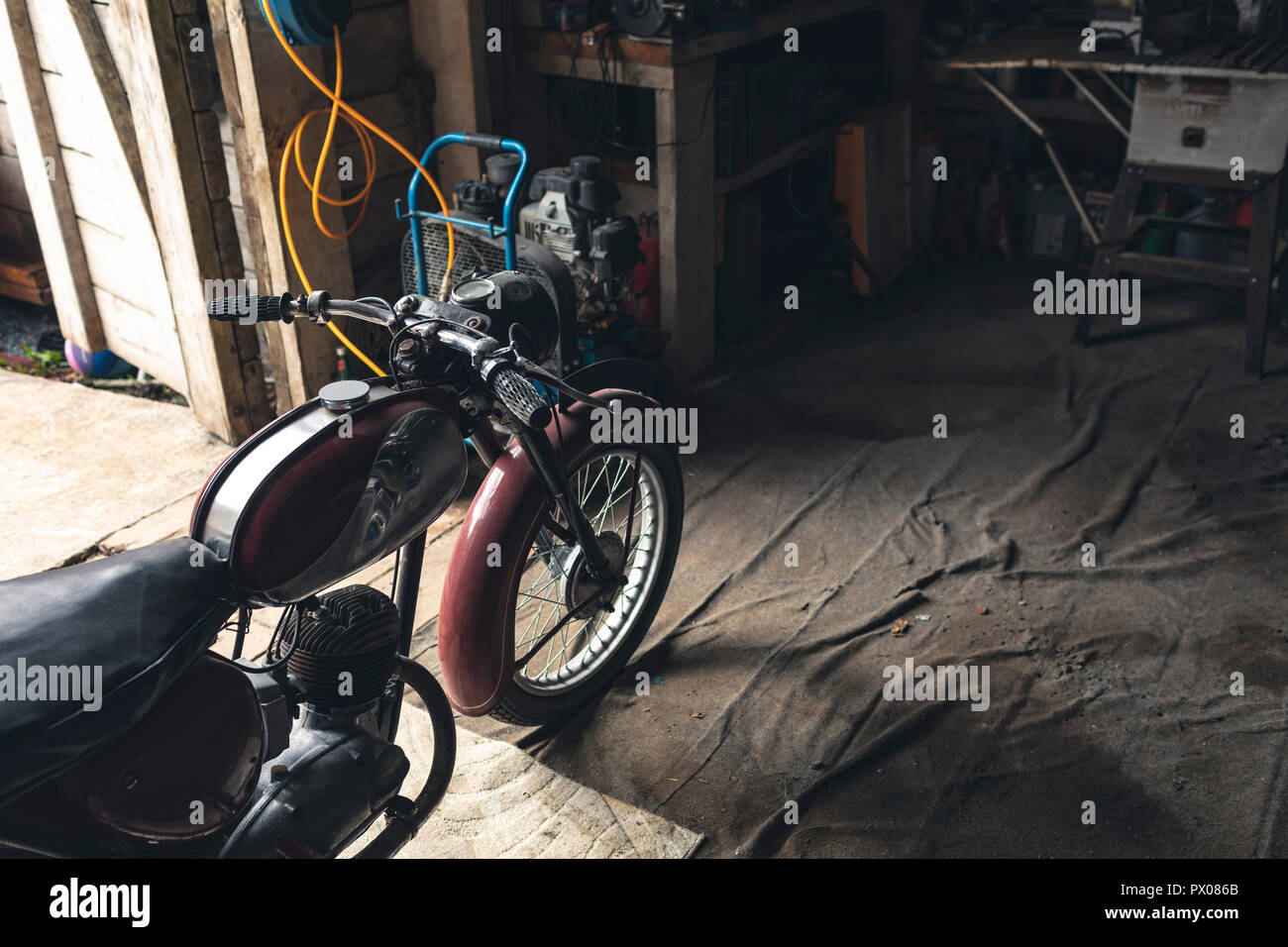 Motorbike standing in garage Stock Photo Alamy