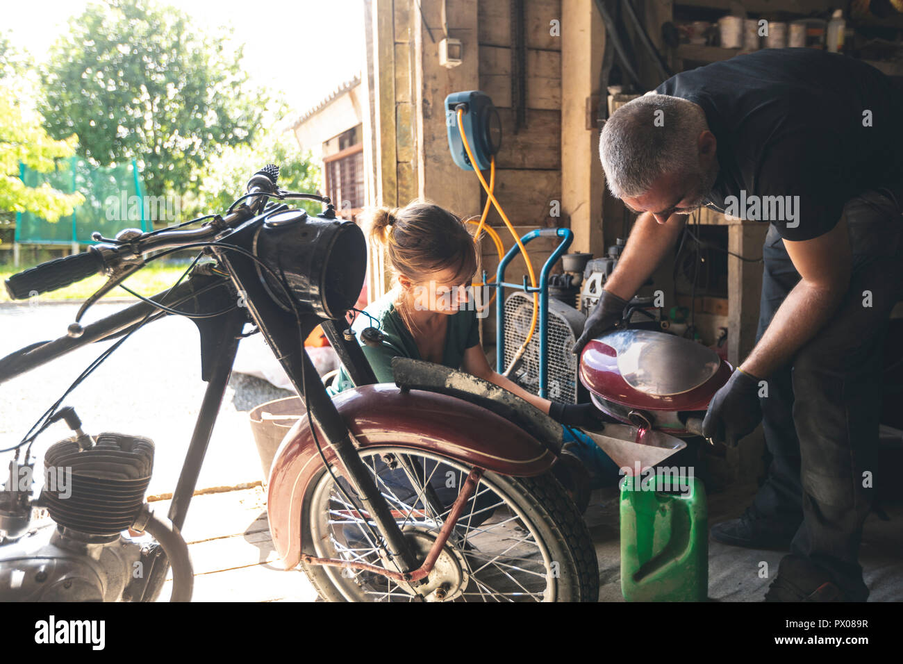 Mechanic removing fuel from fuel tank Stock Photo Alamy