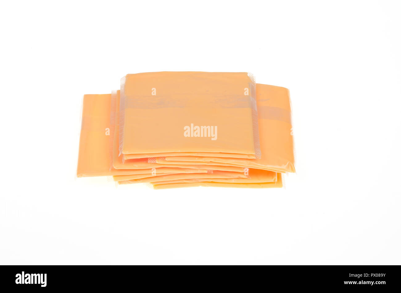 Stack of processed orange american cheese on white Stock Photo