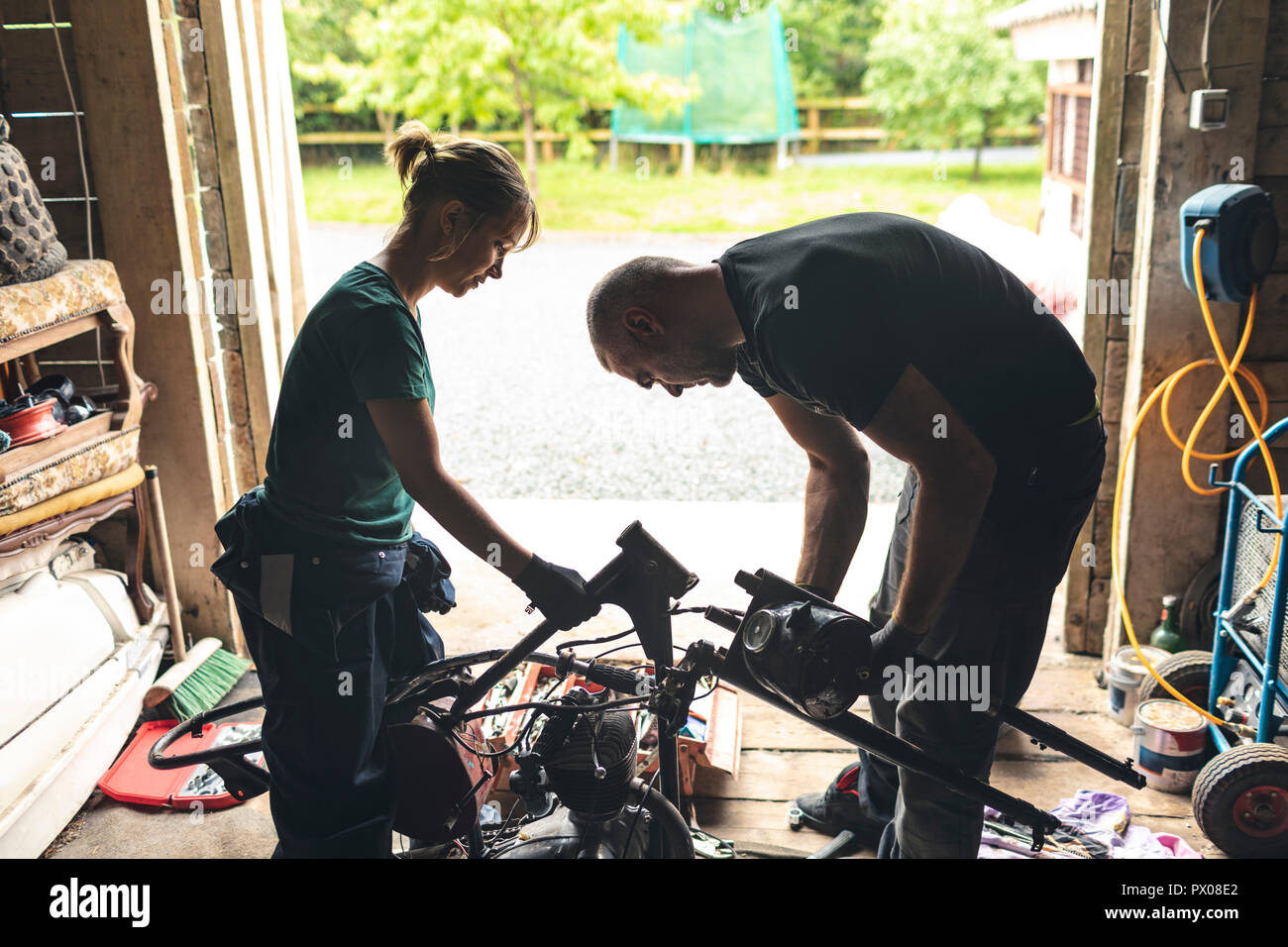 Mature man repairing motorbike hi-res stock photography and images - Alamy