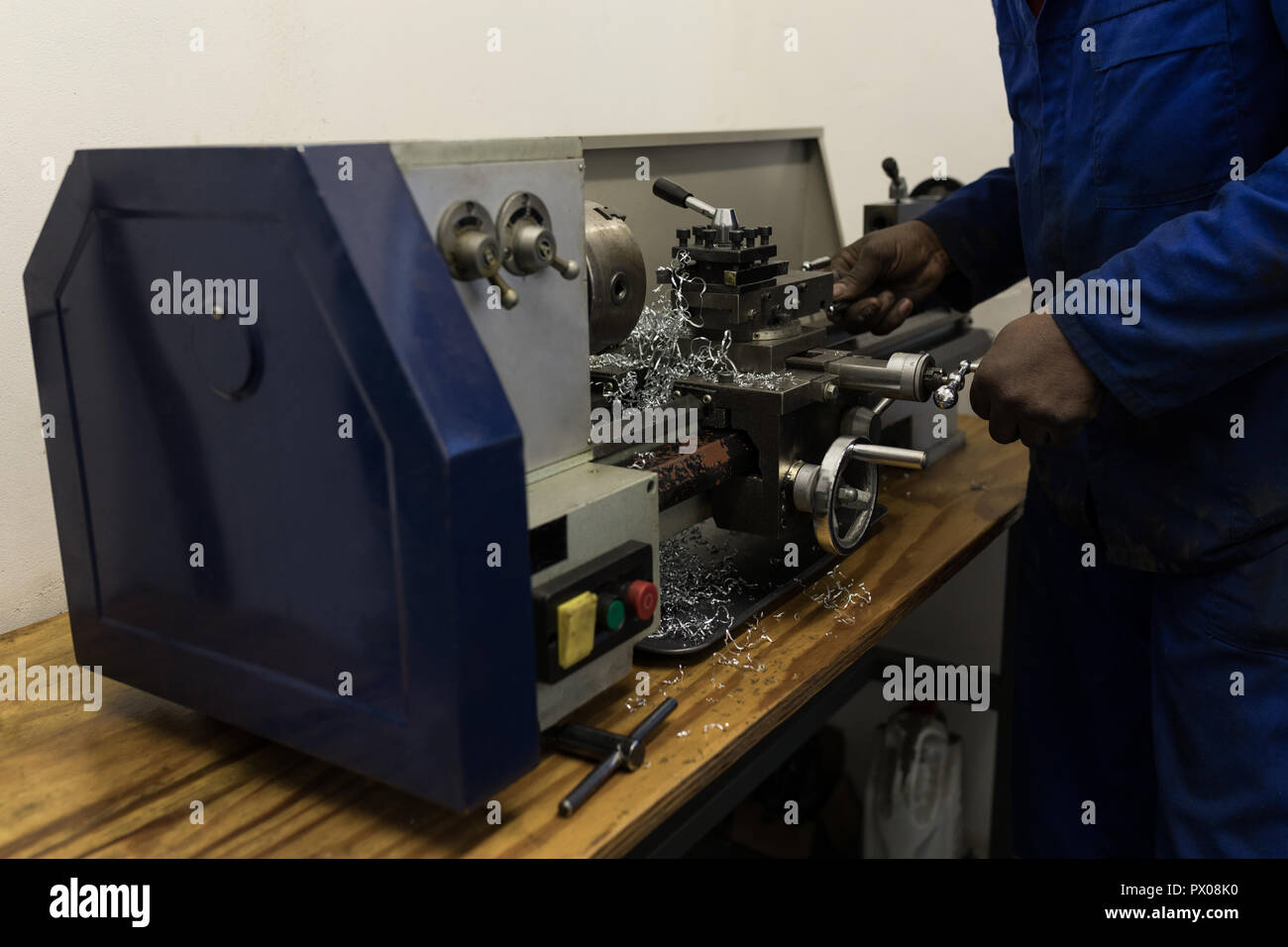 Blacksmith using machine in workshop Stock Photo