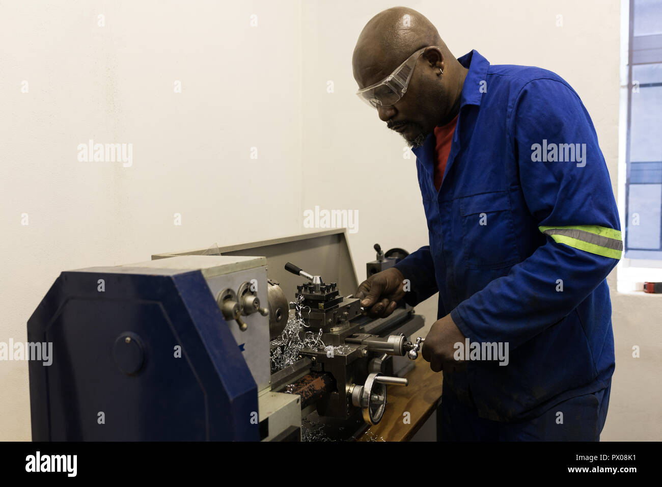 Blacksmith using machine in workshop Stock Photo