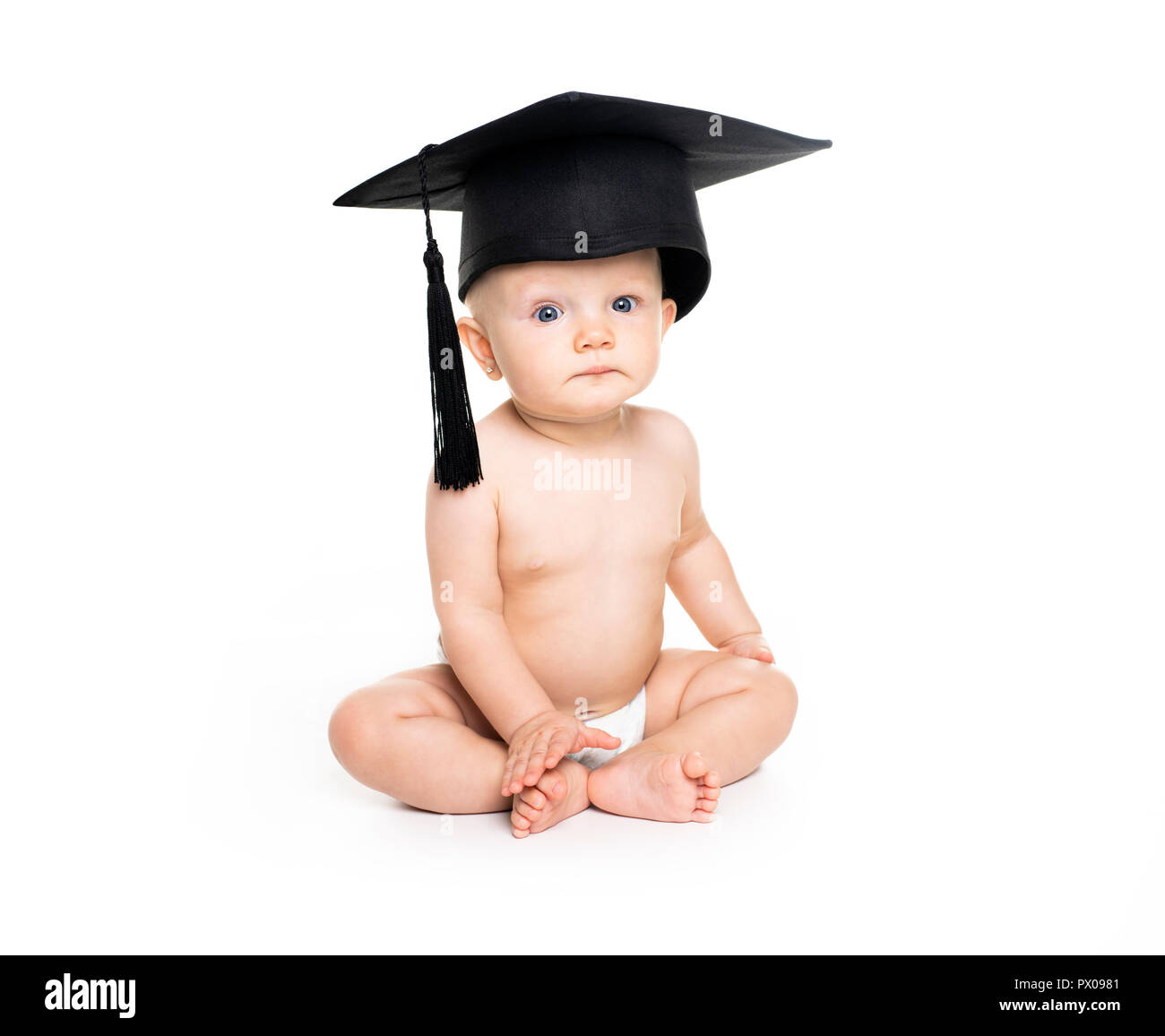 A Portrait of a sitting baby girl with a graduation cap Stock Photo