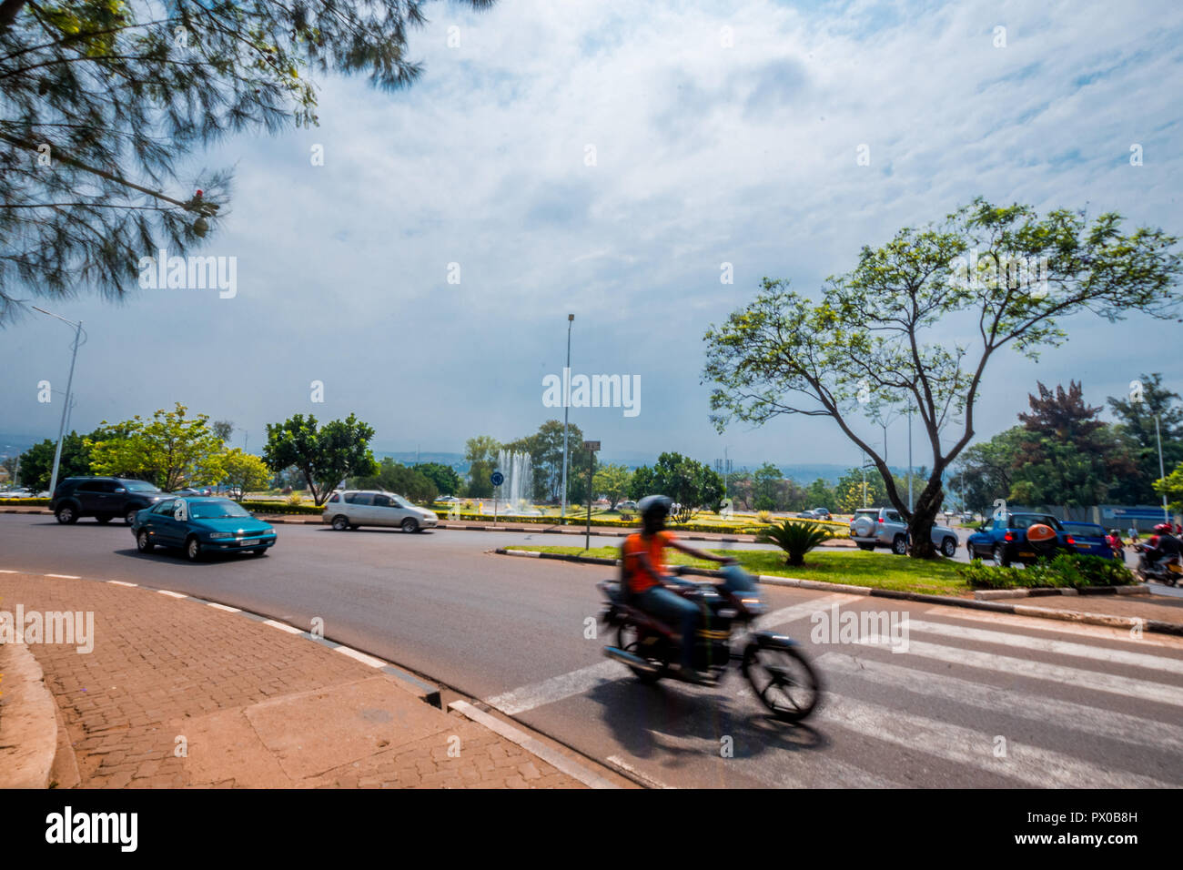 Kigali, Rwanda - September 20, 2018: the blur of a 'moto' (motorbike) passing by on a road near the city centre Stock Photo