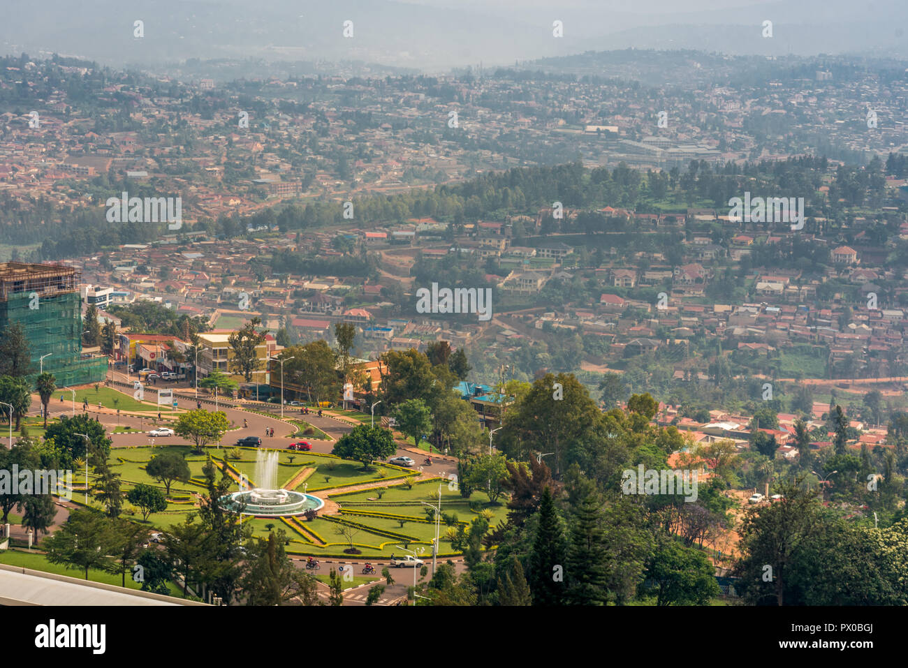 Kigali, Rwanda - September 21, 2018: A high angle view of the fountain roundabout near the city centre with rows of hills fading into the distance Stock Photo