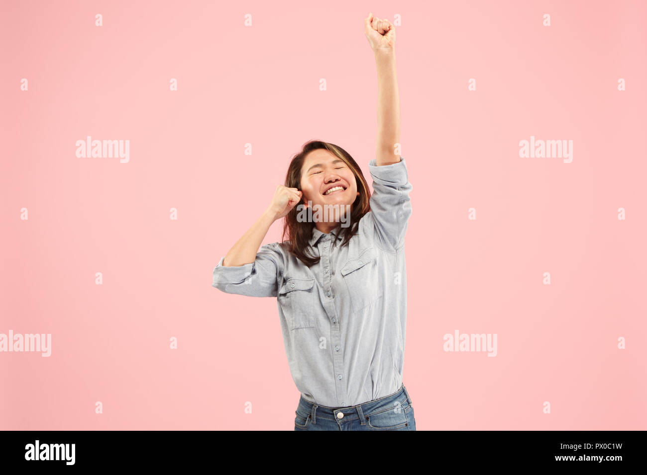 I won. Winning success happy woman celebrating being a winner. Dynamic image of caucasian female model on pink studio background. Victory, delight concept. Human facial emotions concept. Trendy colors Stock Photo