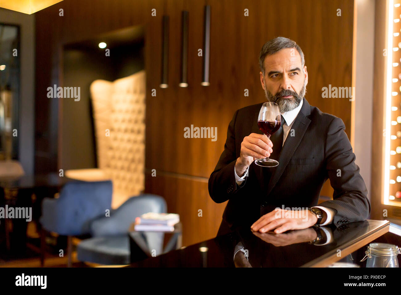 Portrait of senior handsome man drinking red wine Stock Photo - Alamy