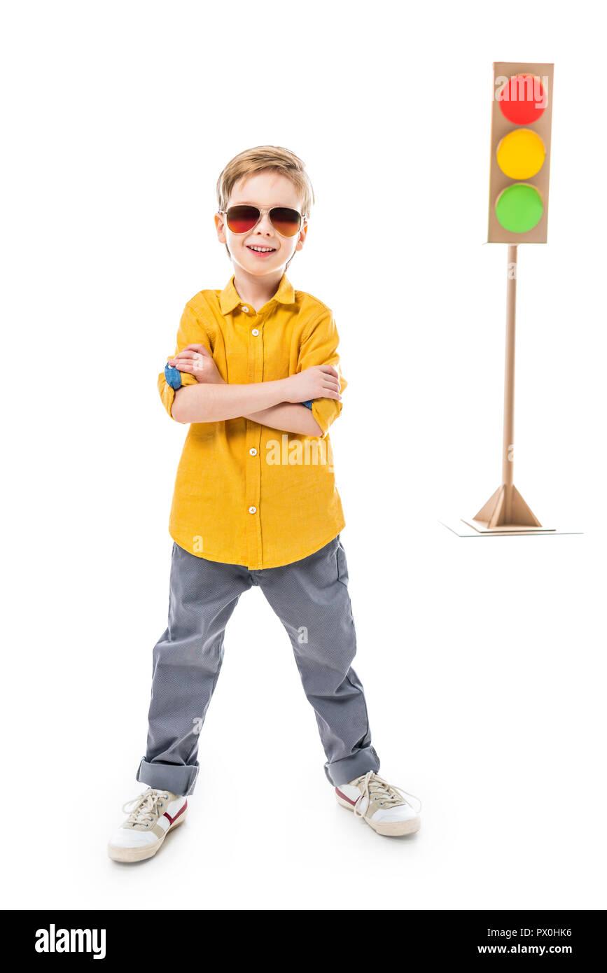smiling boy in sunglasses posing with crossed arms, isolated on white with cardboard traffic lights, isolated on white Stock Photo