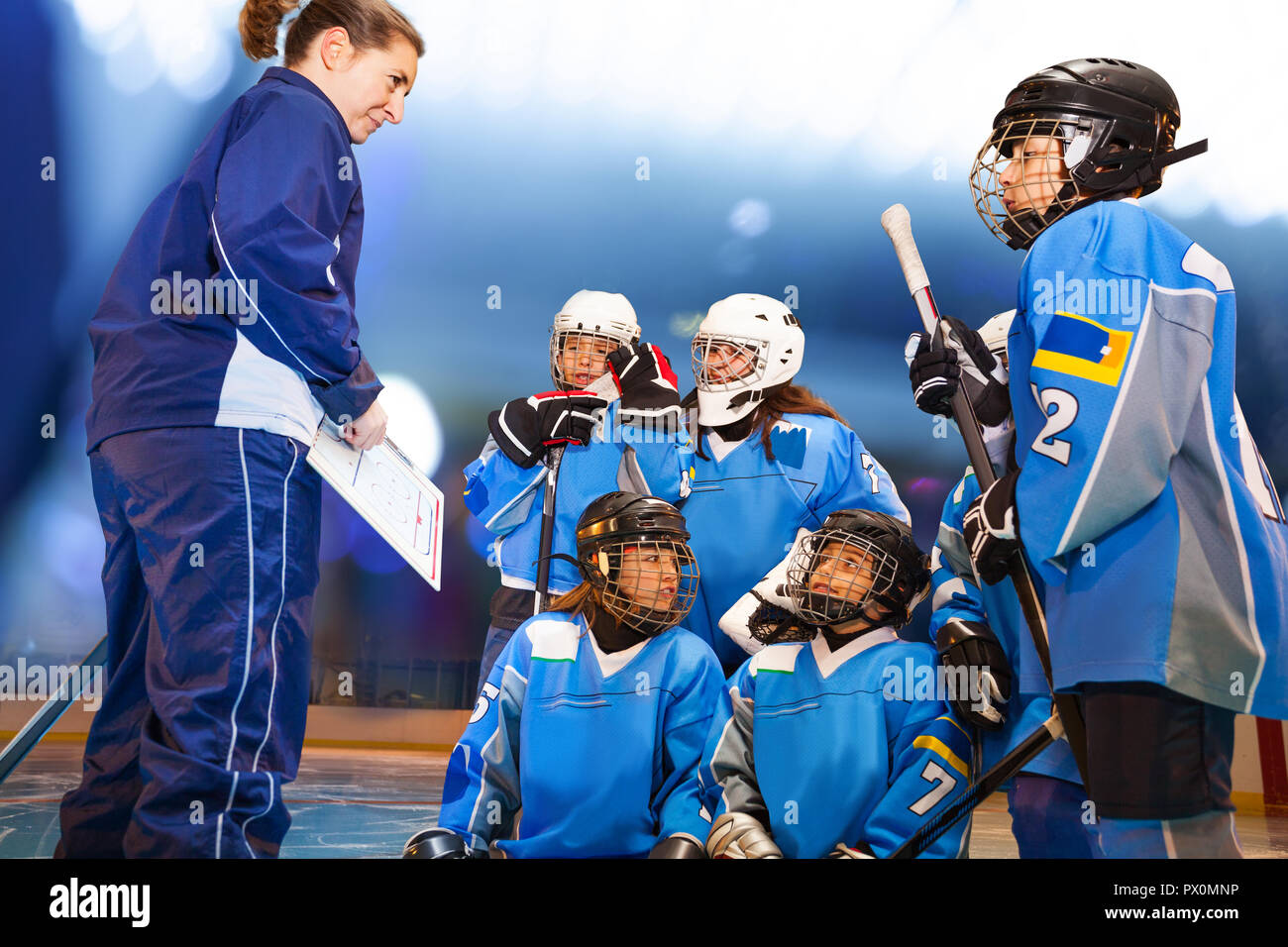 Female coach showing game plan to ice hockey team Stock Photo Alamy