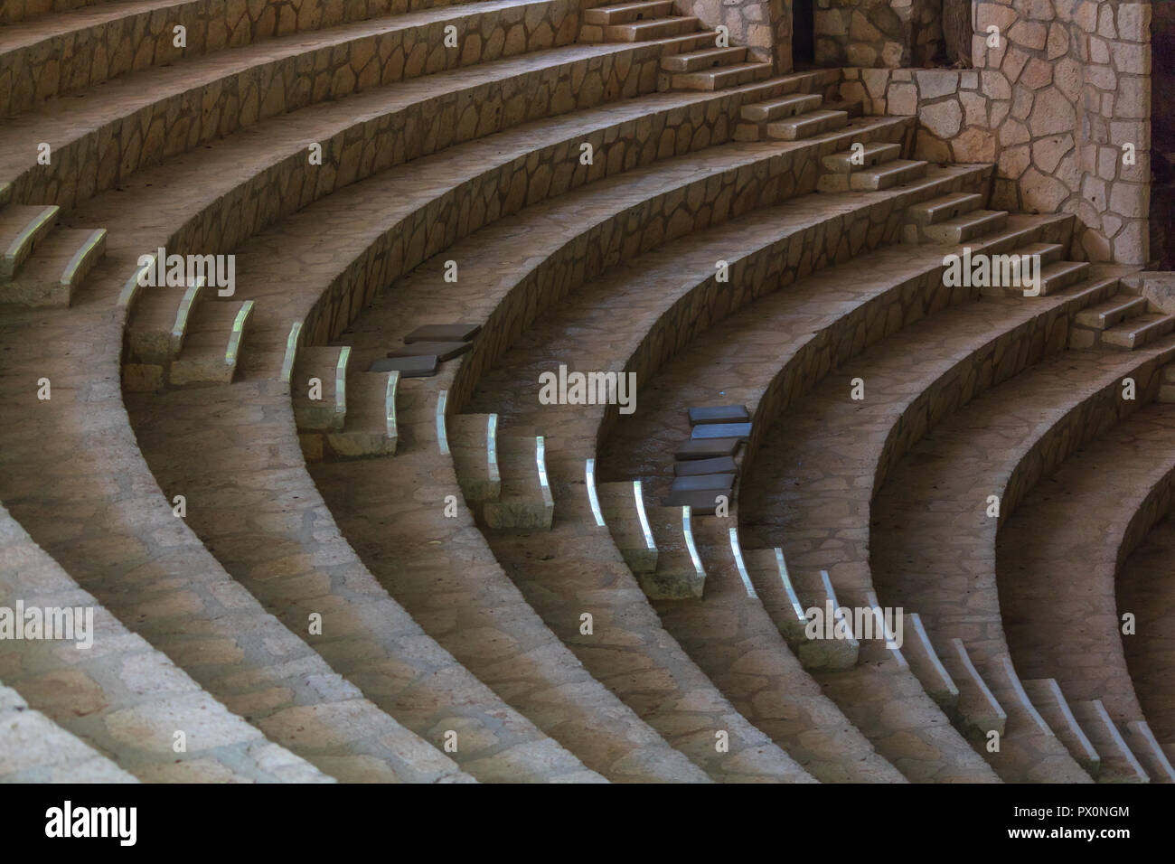 Empty amphitheater steps made of white stone. There is harmony in empty buildings. the parallel curves please the eye and bring peace to OCD people Stock Photo