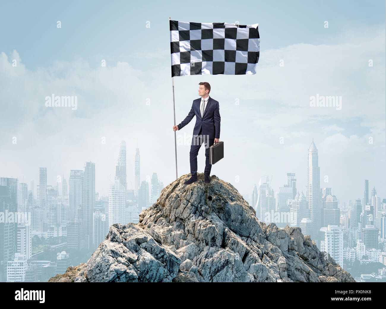 Successful businessman on the top of a city holding goal flag Stock ...