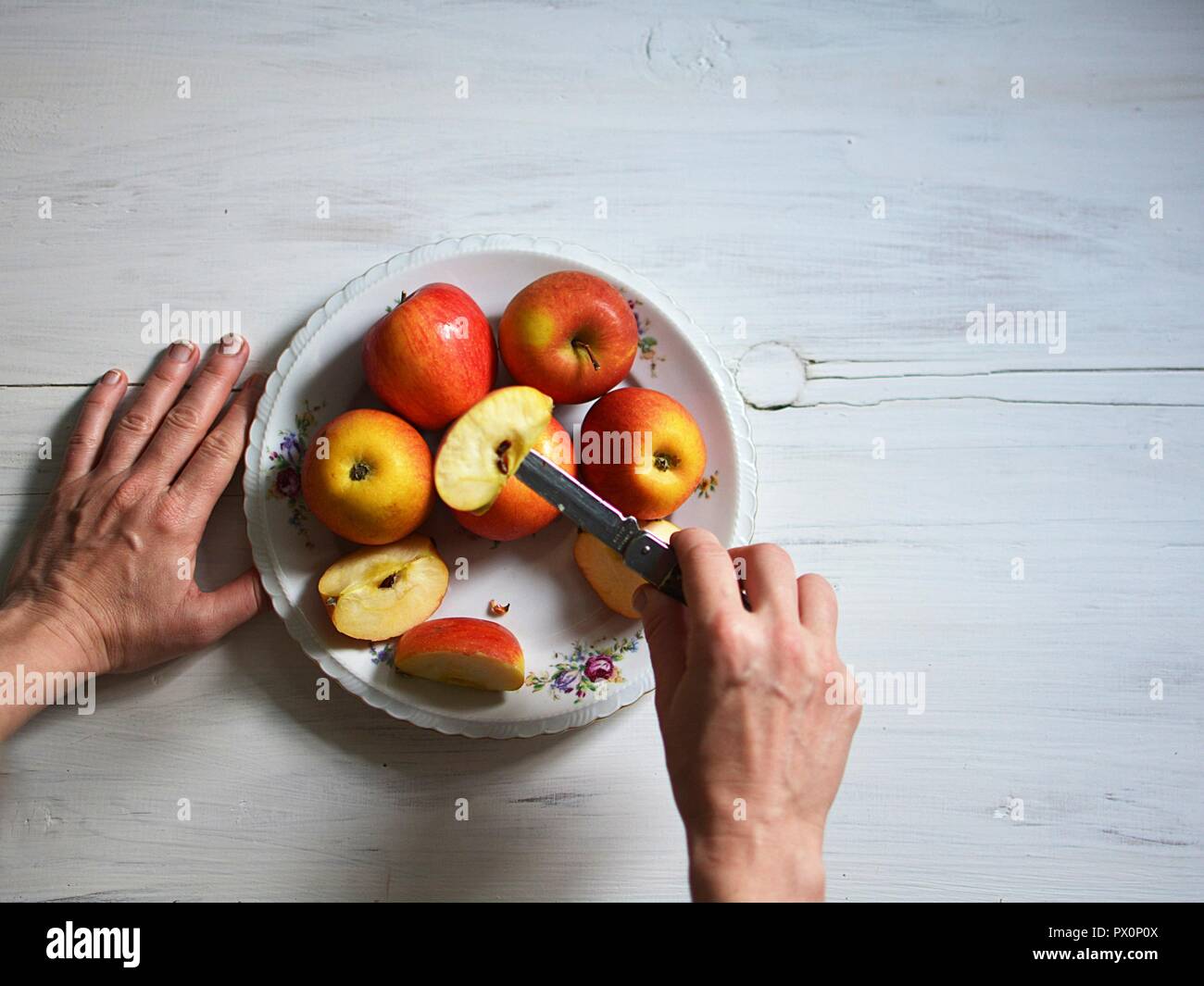 cutting apples with an old knife Stock Photo Alamy