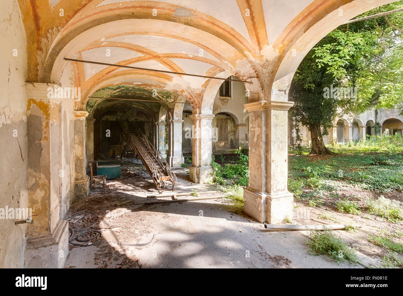 Hallway and a courtyard at an abandoned monastery in Italy. Stock Photo