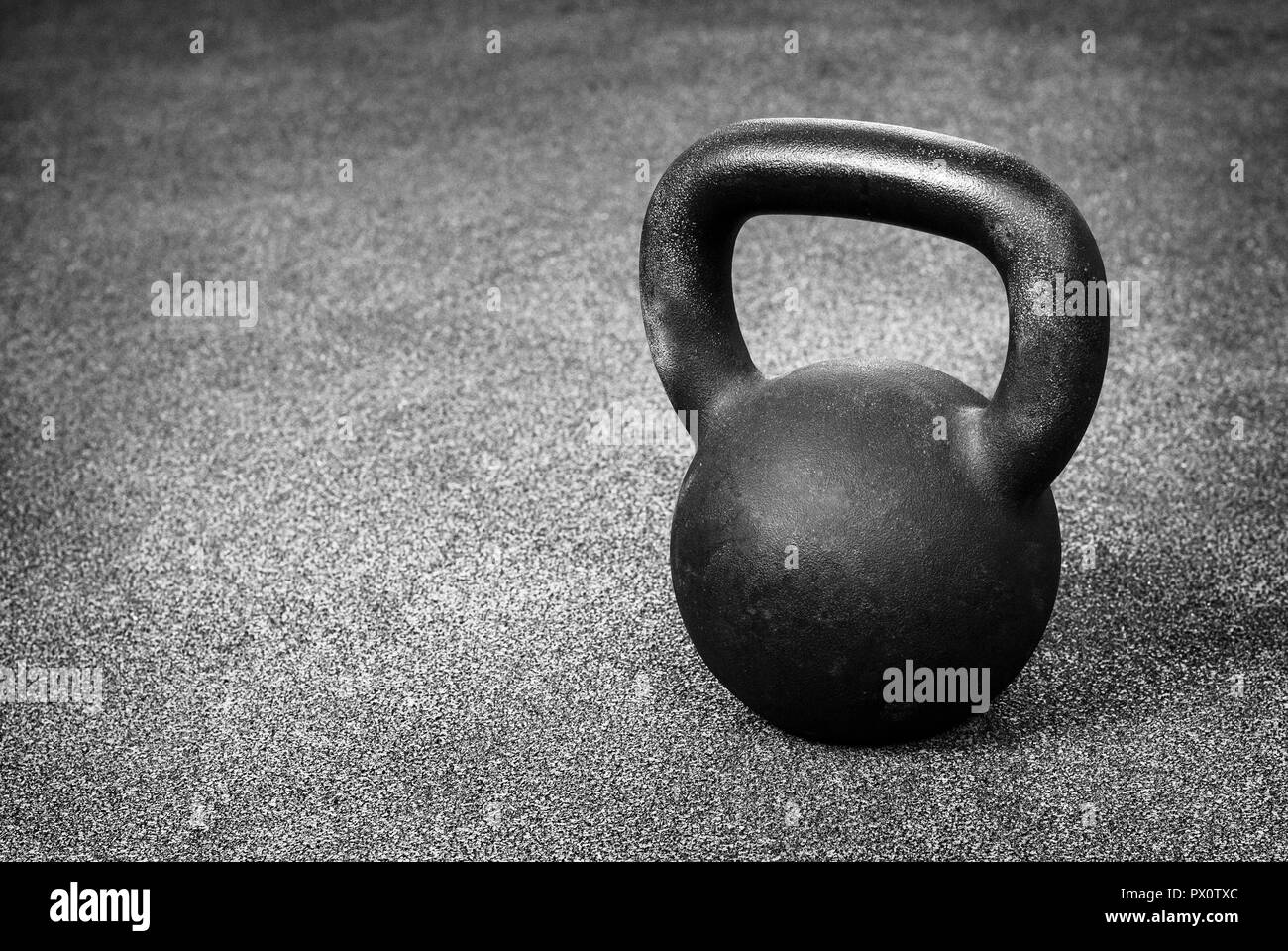Black heavy kettlebell on gray floor, background Stock Photo Alamy
