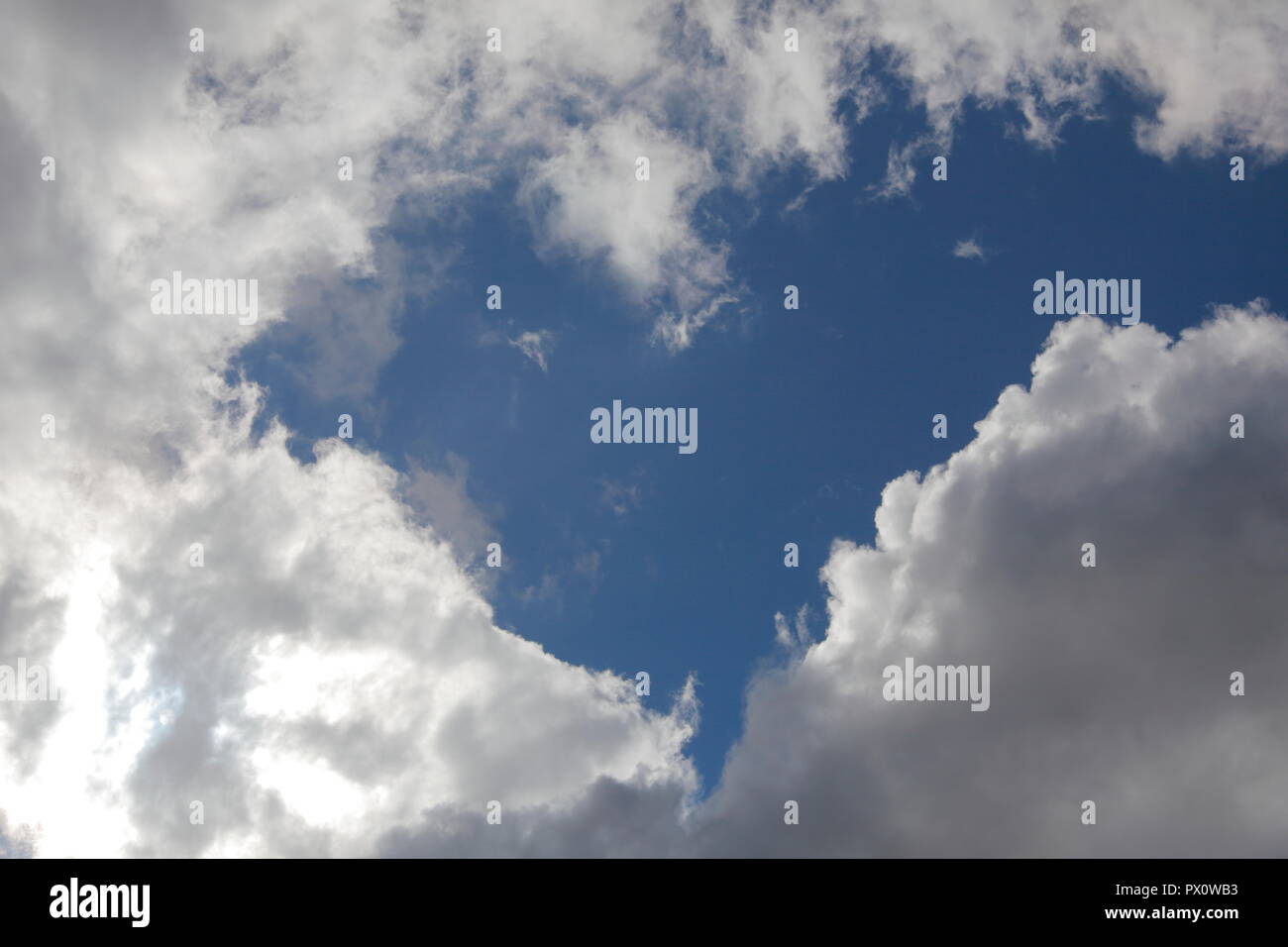 A heart shape gap in clouds Stock Photo